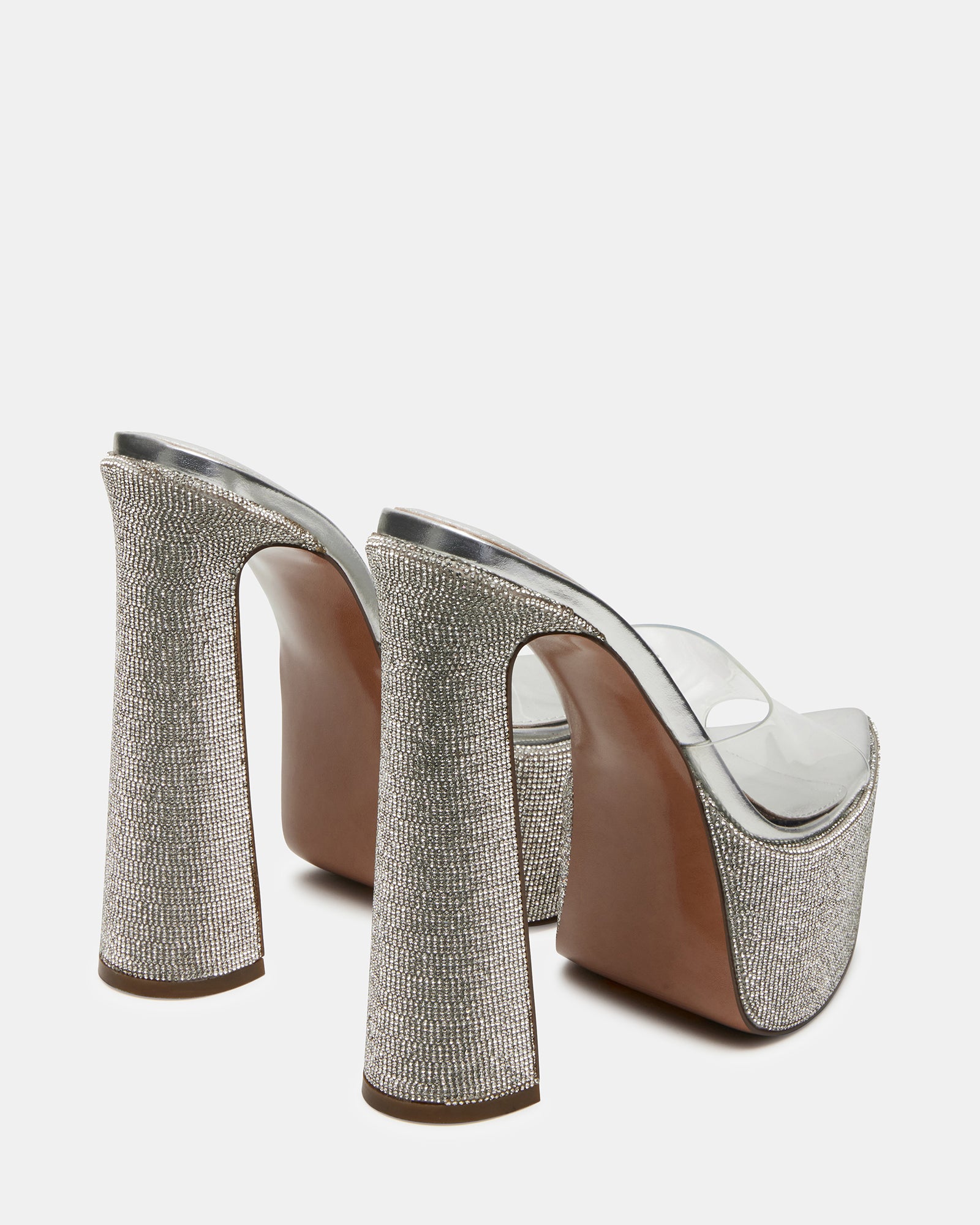 Side view of the mules highlighting the pointed toe and platform design.