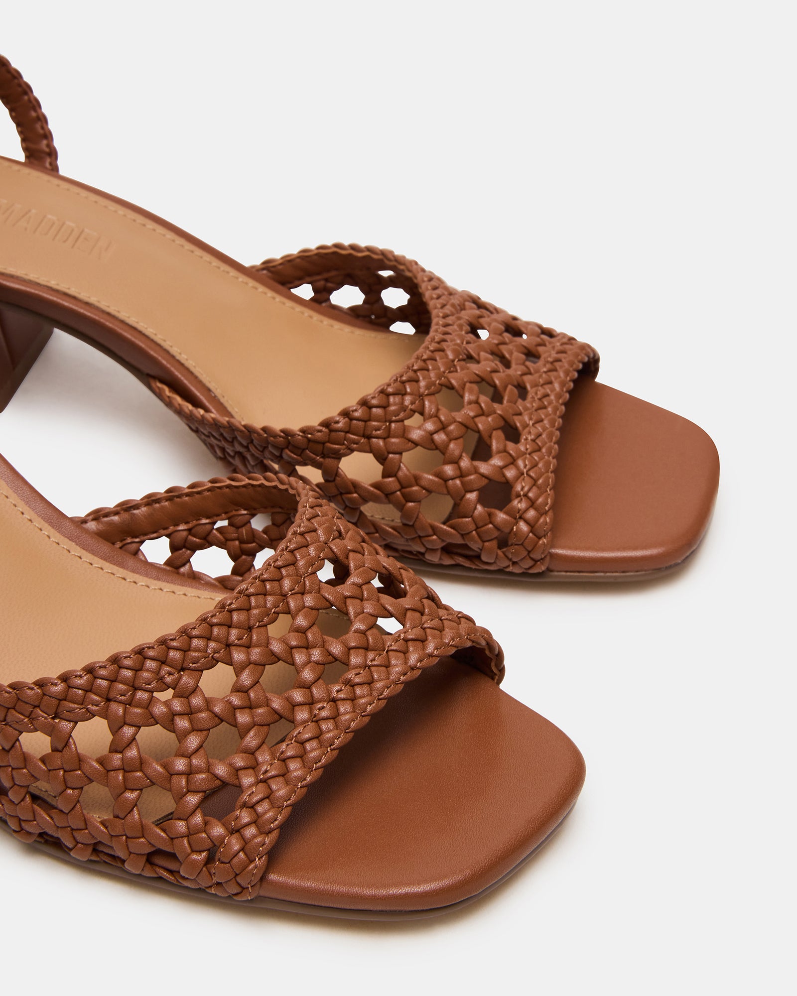 Model wearing the Soleil Tan block heel shoes with ankle strap at a sunny outdoor event.
