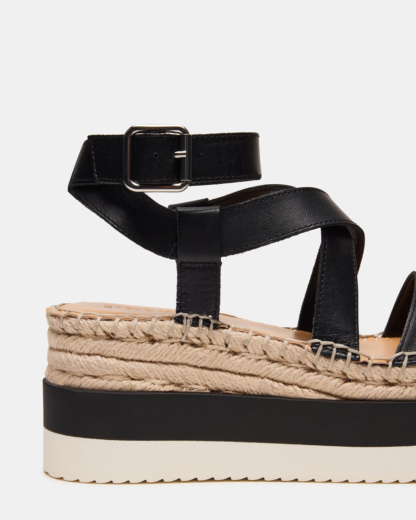 Model wearing SOREN black leather sandals, showcasing the chic style.