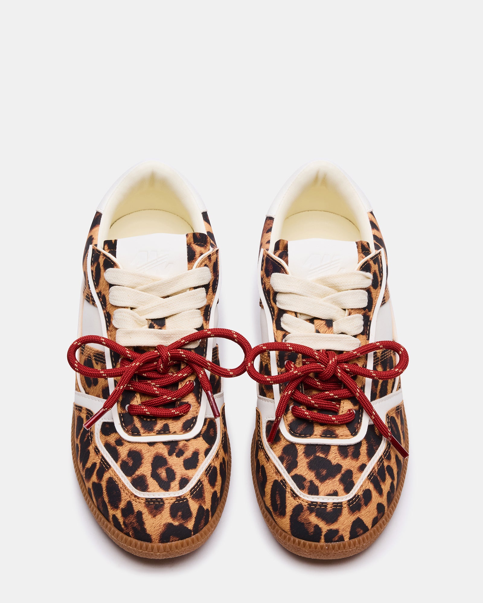 Close-up of lace-up detail and leopard pattern on low-top sneakers