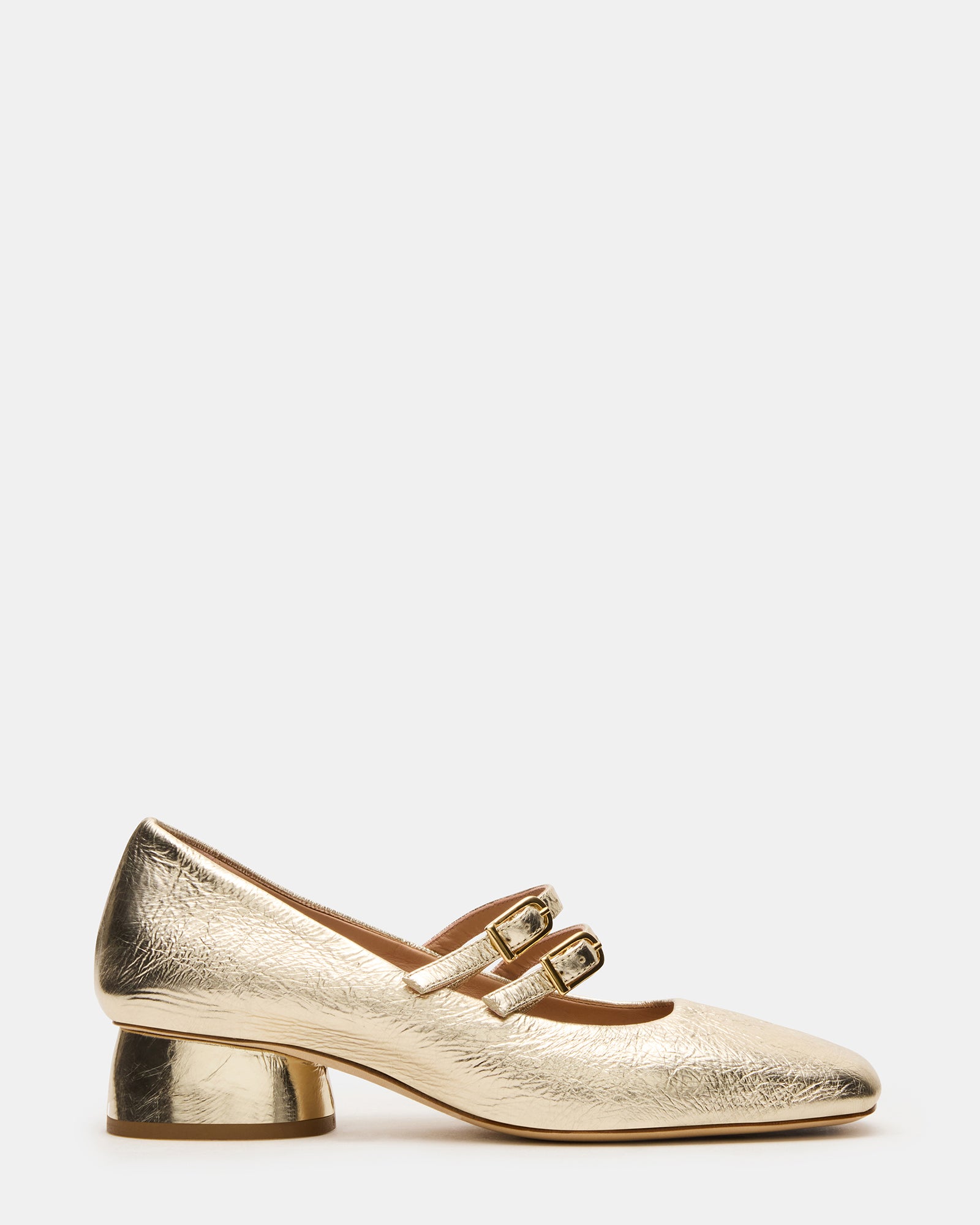 Side view of gold Mary Jane high heels showcasing leather texture and strap design