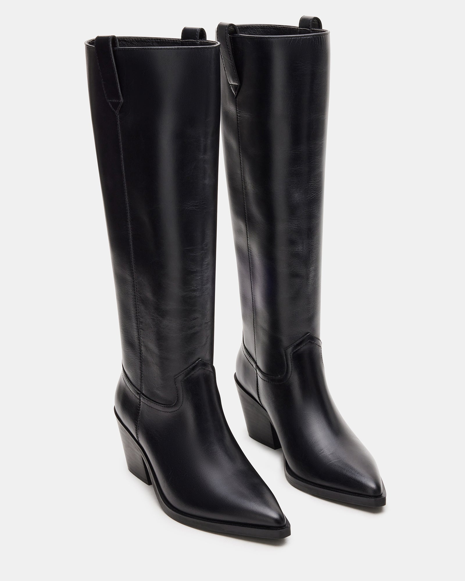 Model wearing the knee-high black boots with jeans for a stylish look.