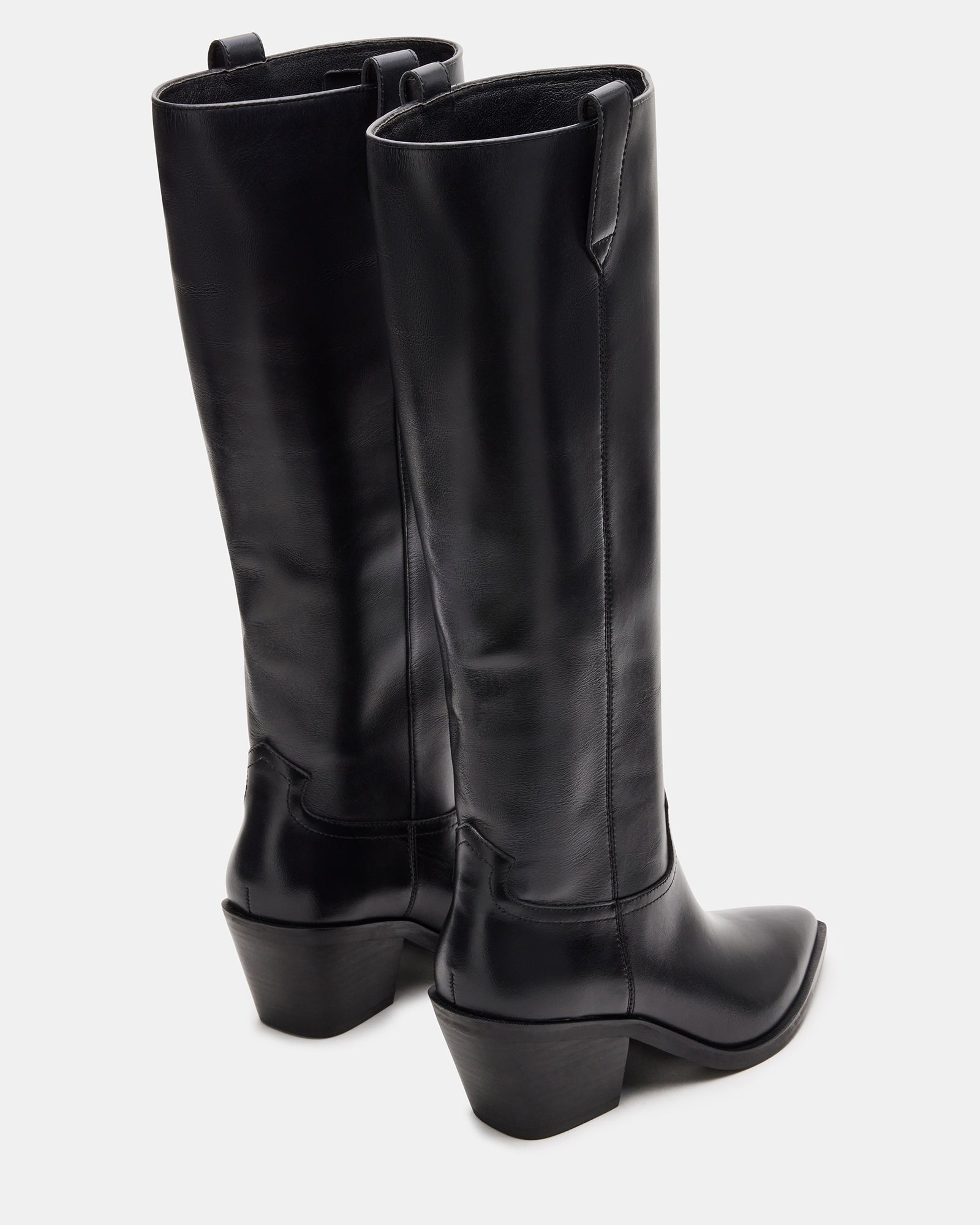 Model wearing the knee-high black boots with jeans for a stylish look.