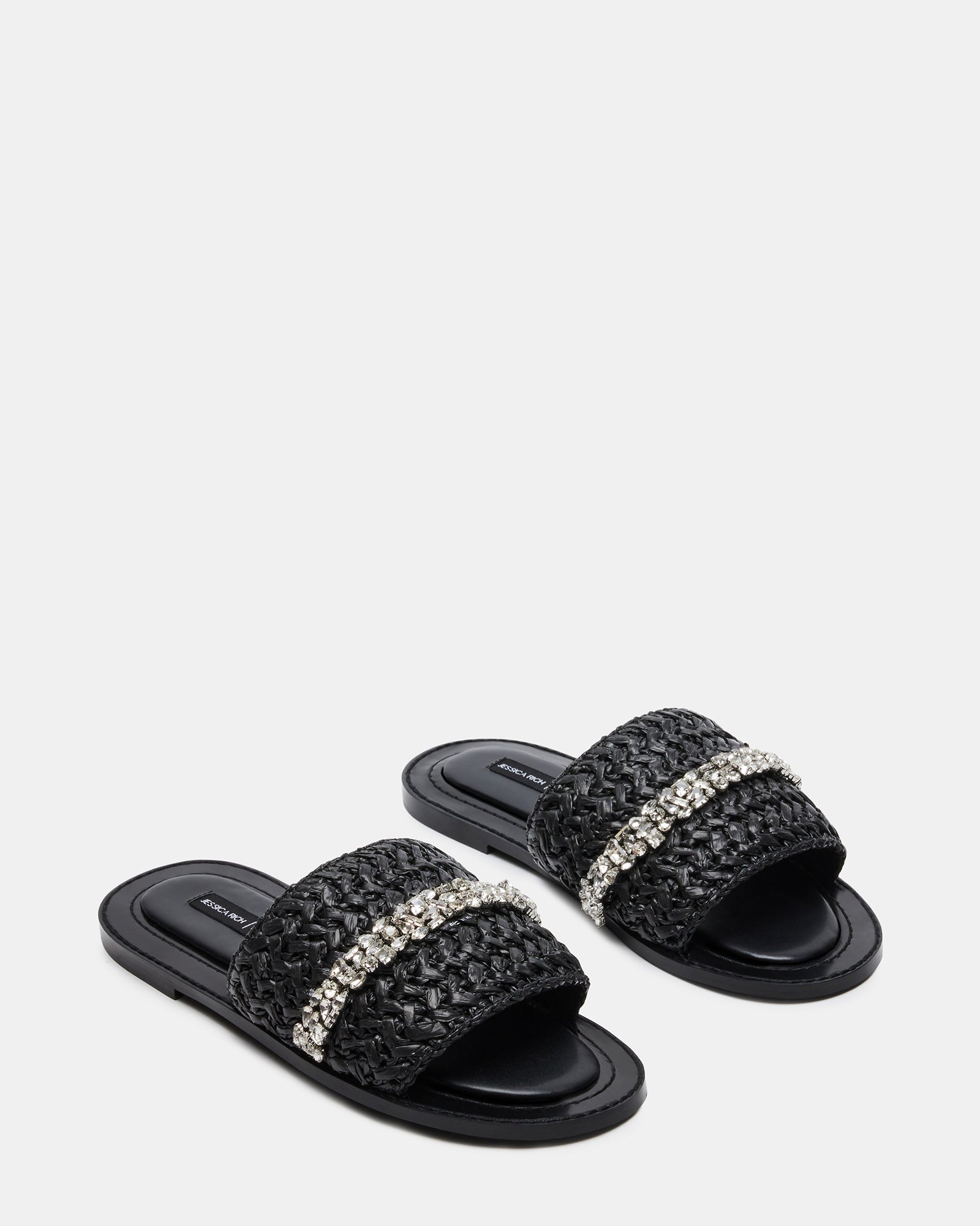 Close-up of raffia material and decorative stones on designer sandals