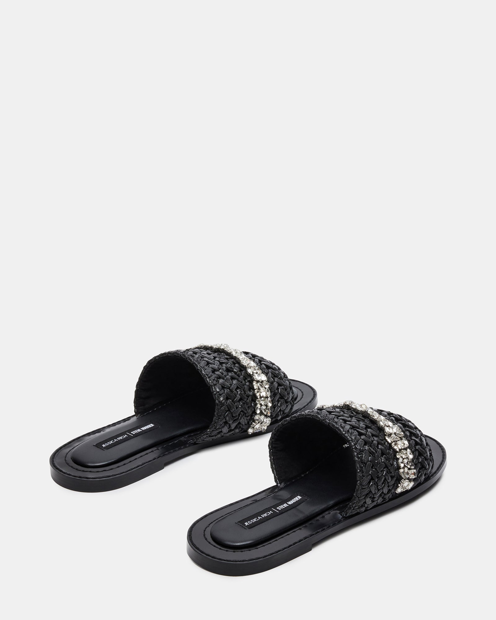 Close-up of raffia material and decorative stones on designer sandals