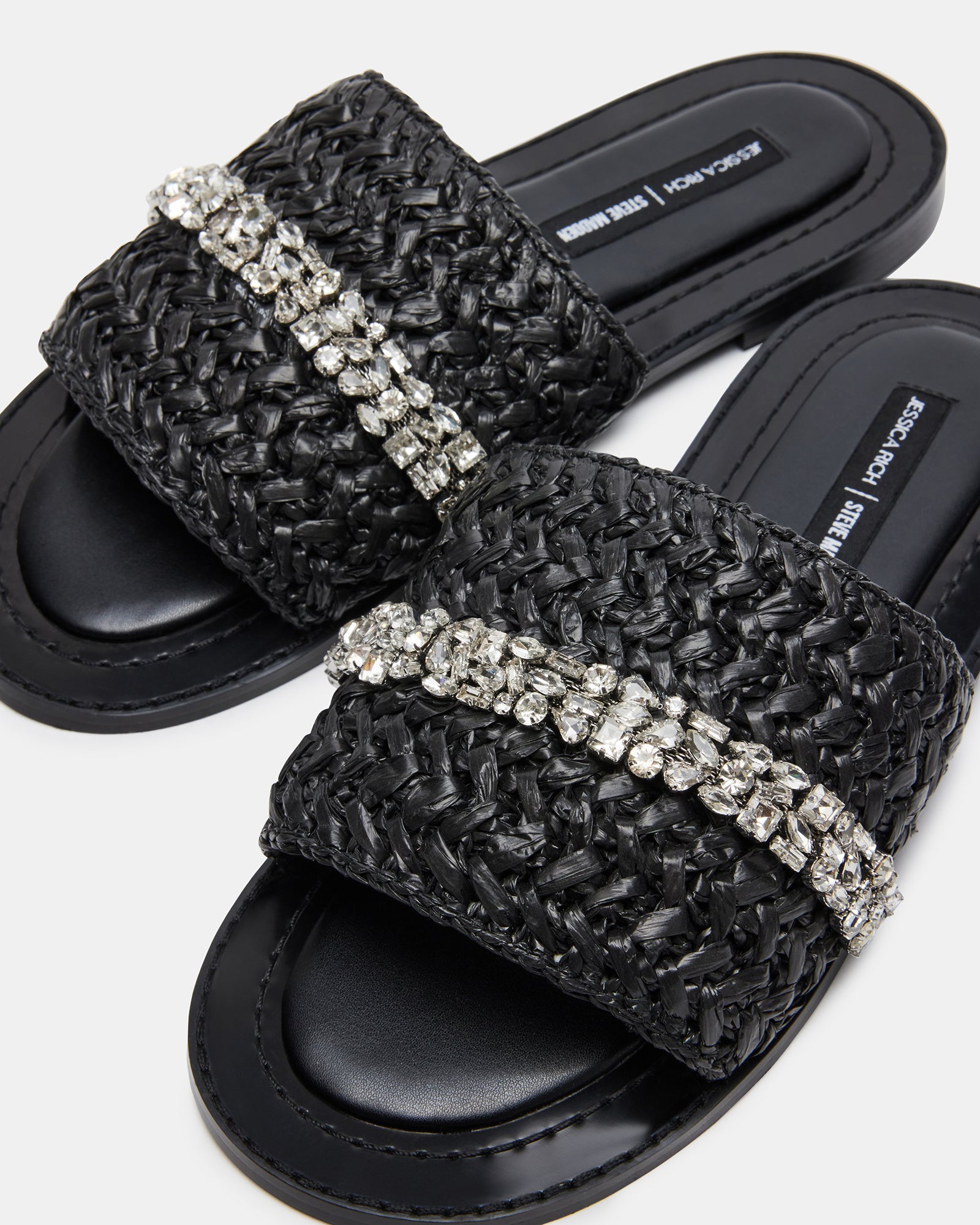 Model wearing black raffia sandals for a stylish day at the beach or evening event