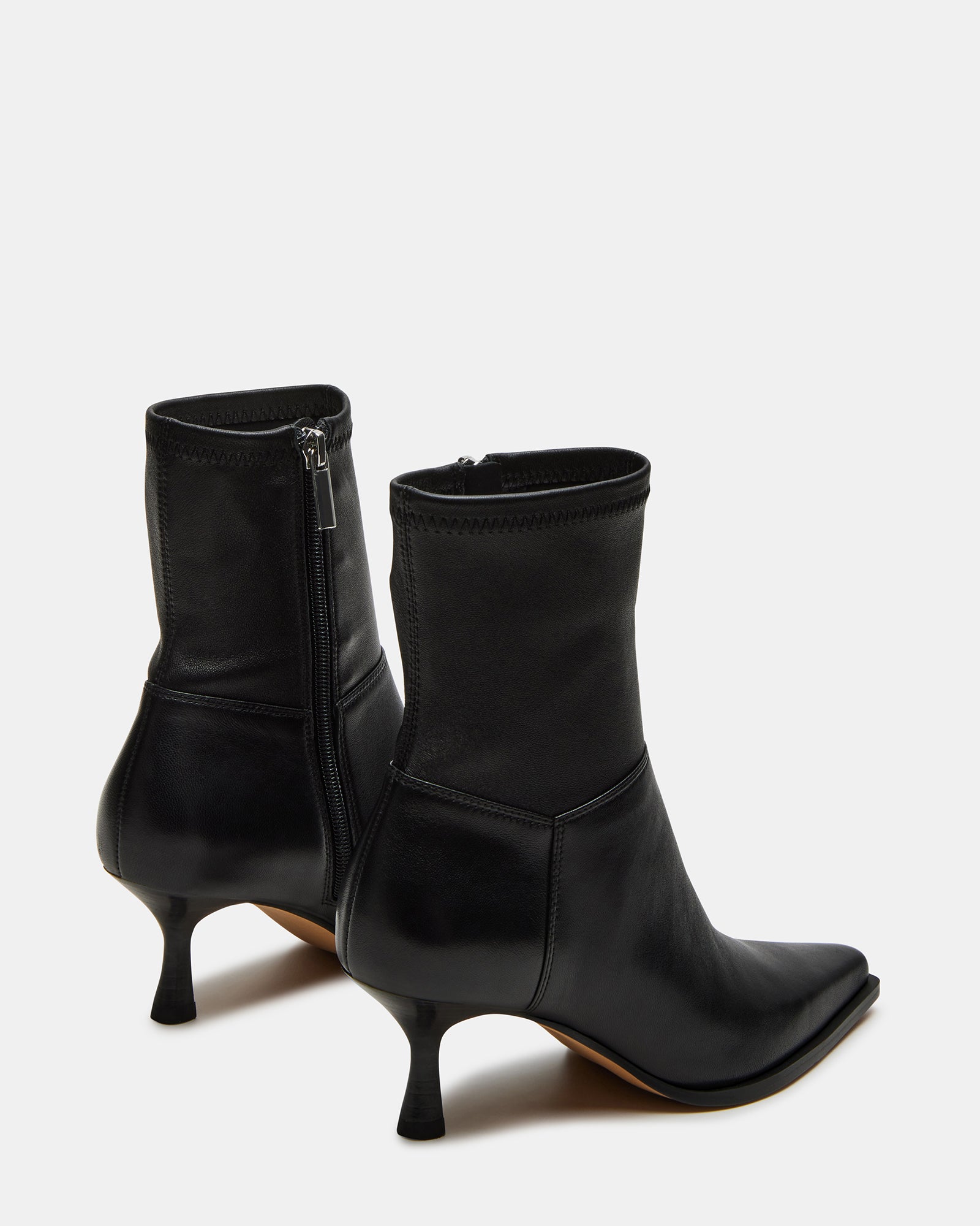 Close-up of the leather upper of the black pointed toe ankle boots.