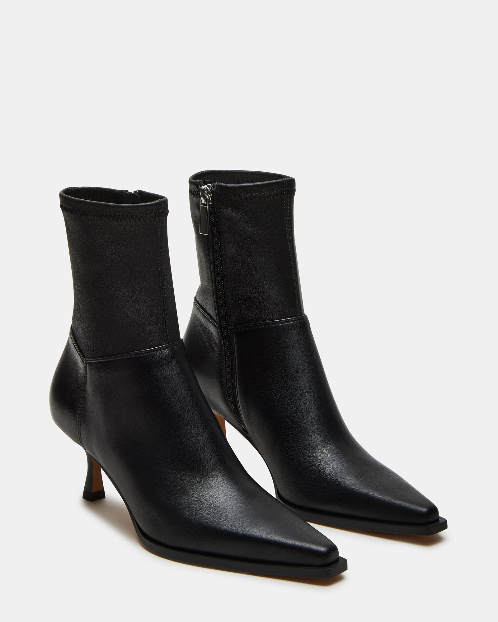 Close-up of the leather upper of the black pointed toe ankle boots.