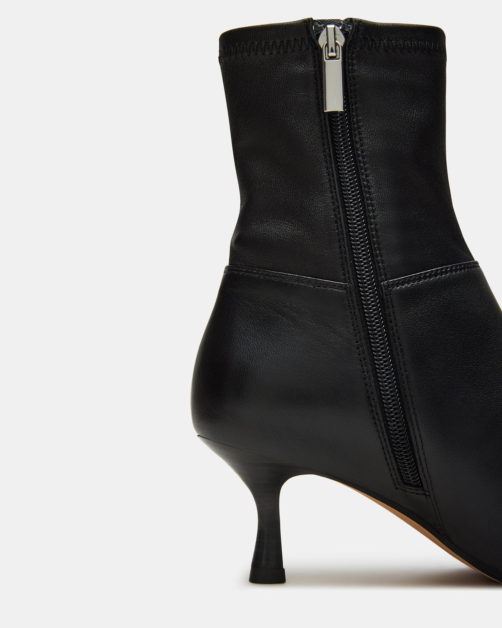 Side view of Stasia black leather ankle boots with pointed toe.