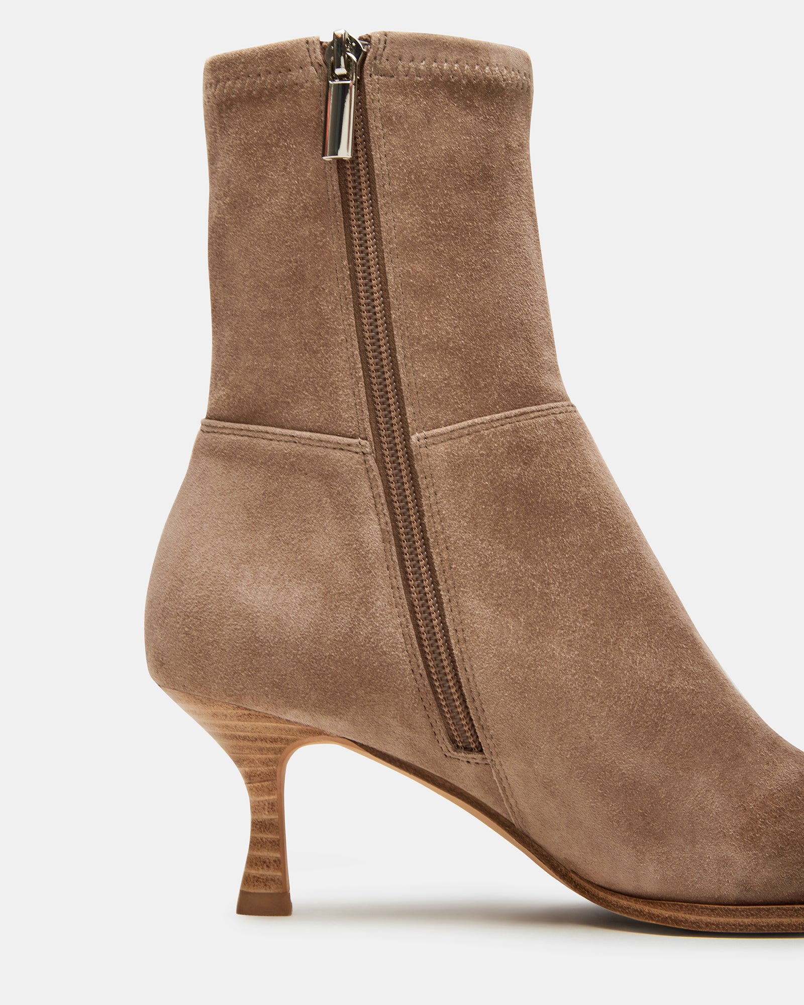 Close-up of brown suede booties showing pointed toe and 2.5-inch kitten heel.