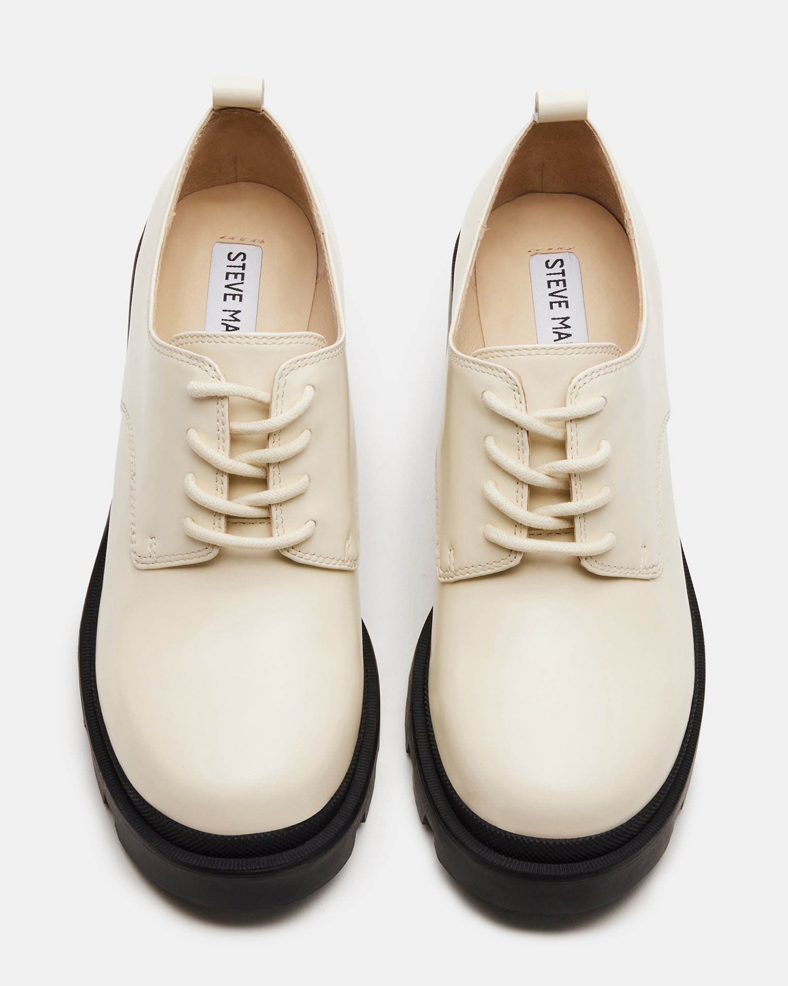 Womens cream leather oxford shoes styled with jeans, showcasing the chunky heel