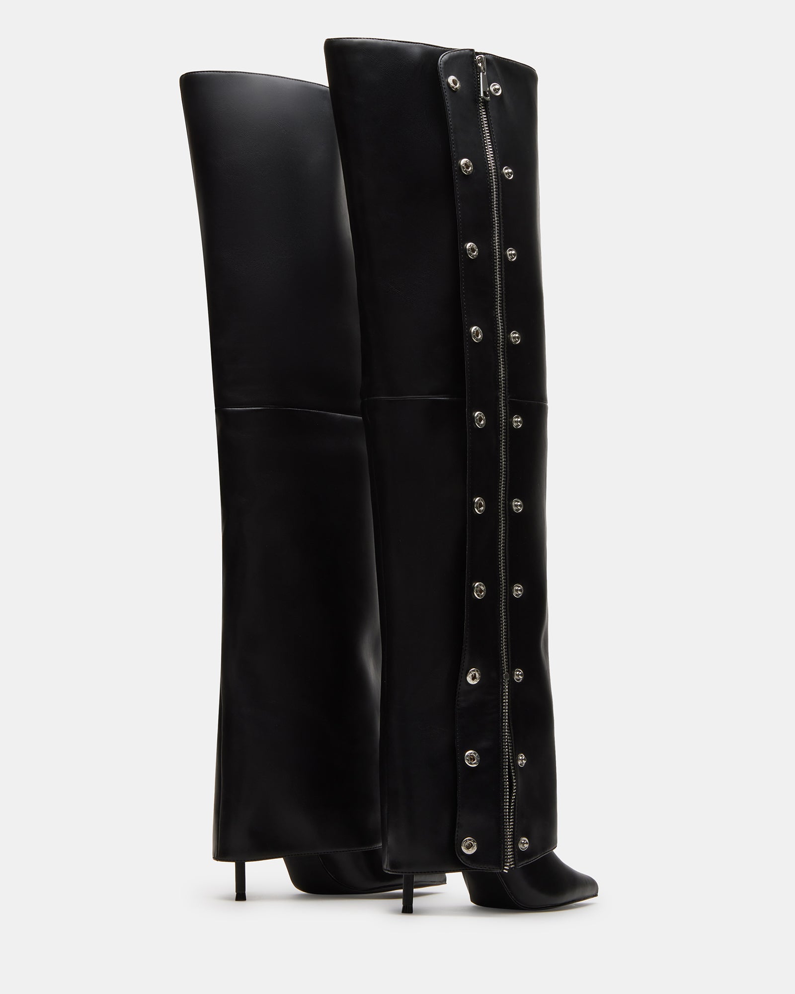 Side angle showing the stiletto heel boots and fold-over cuff in black vegan leather