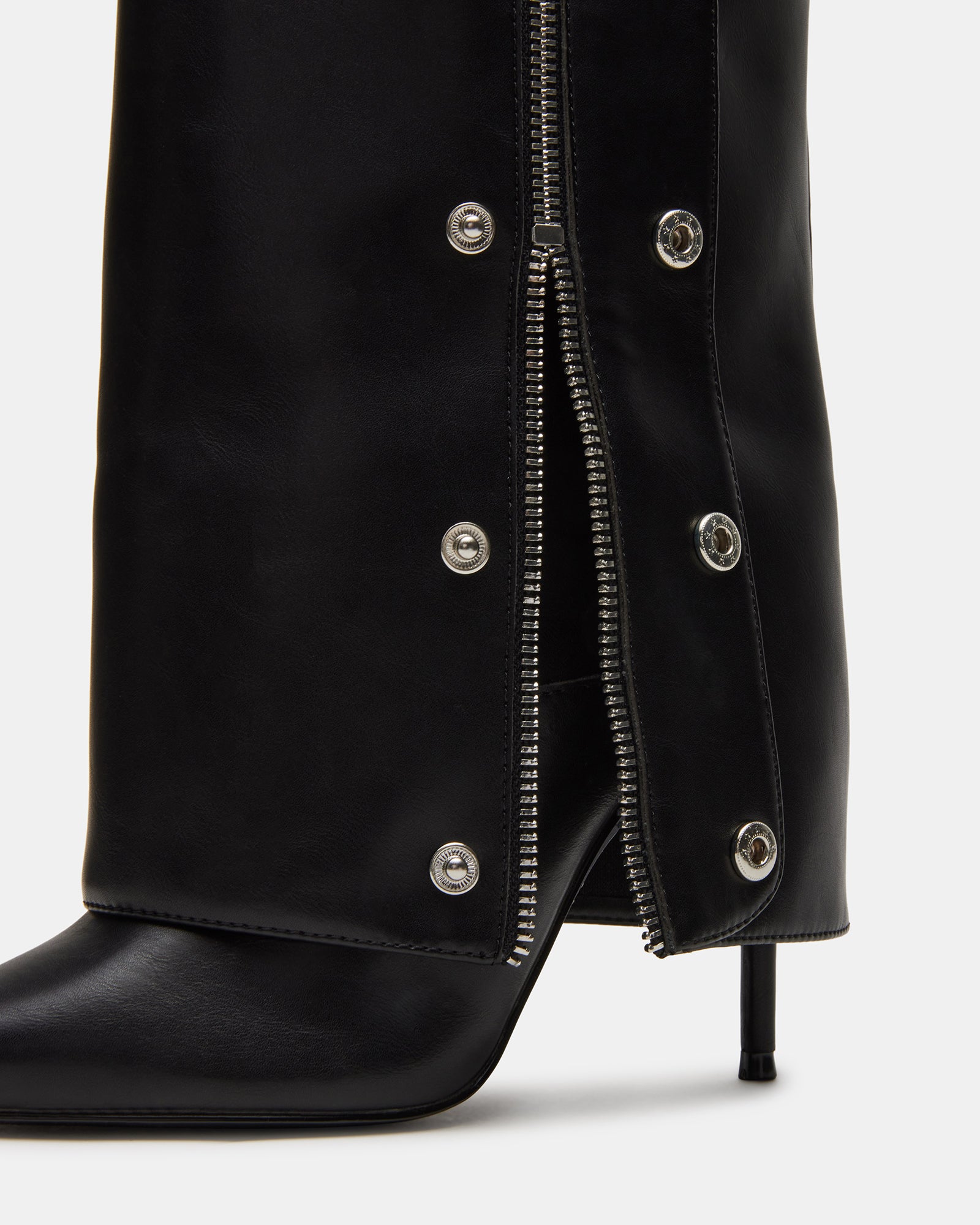 Side angle showing the stiletto heel boots and fold-over cuff in black vegan leather