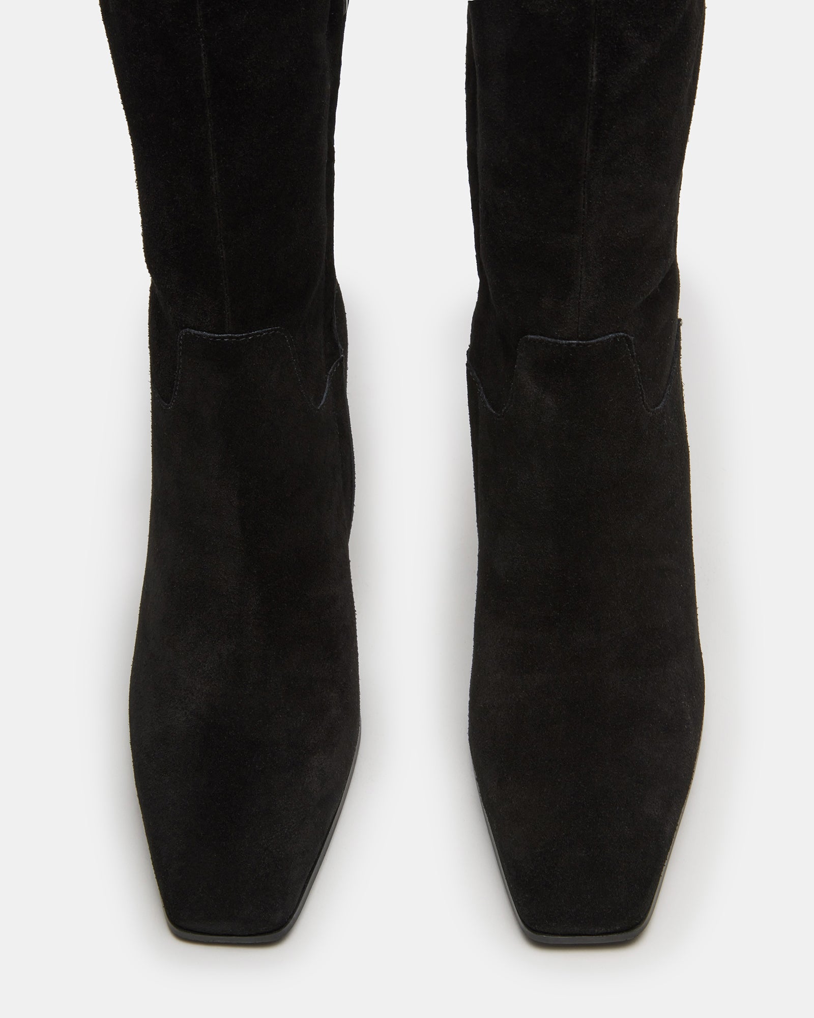 Close-up of heel and shaft of black suede knee high boots