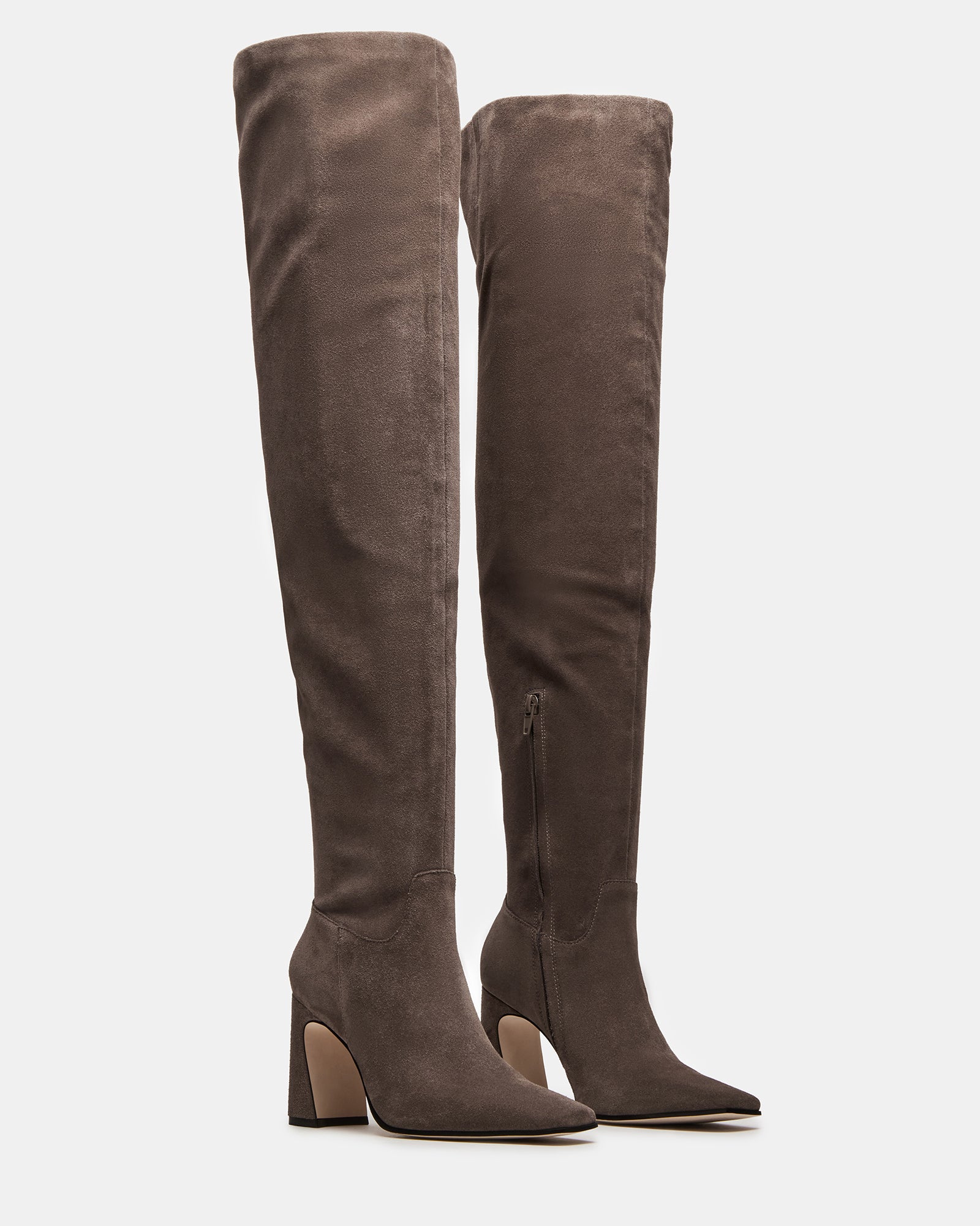 Close-up of black knee high boots no heel detailing on suede texture