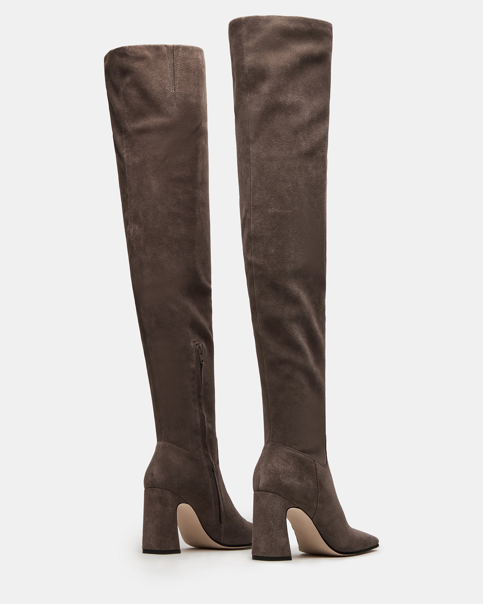 Close-up of black knee high boots no heel detailing on suede texture