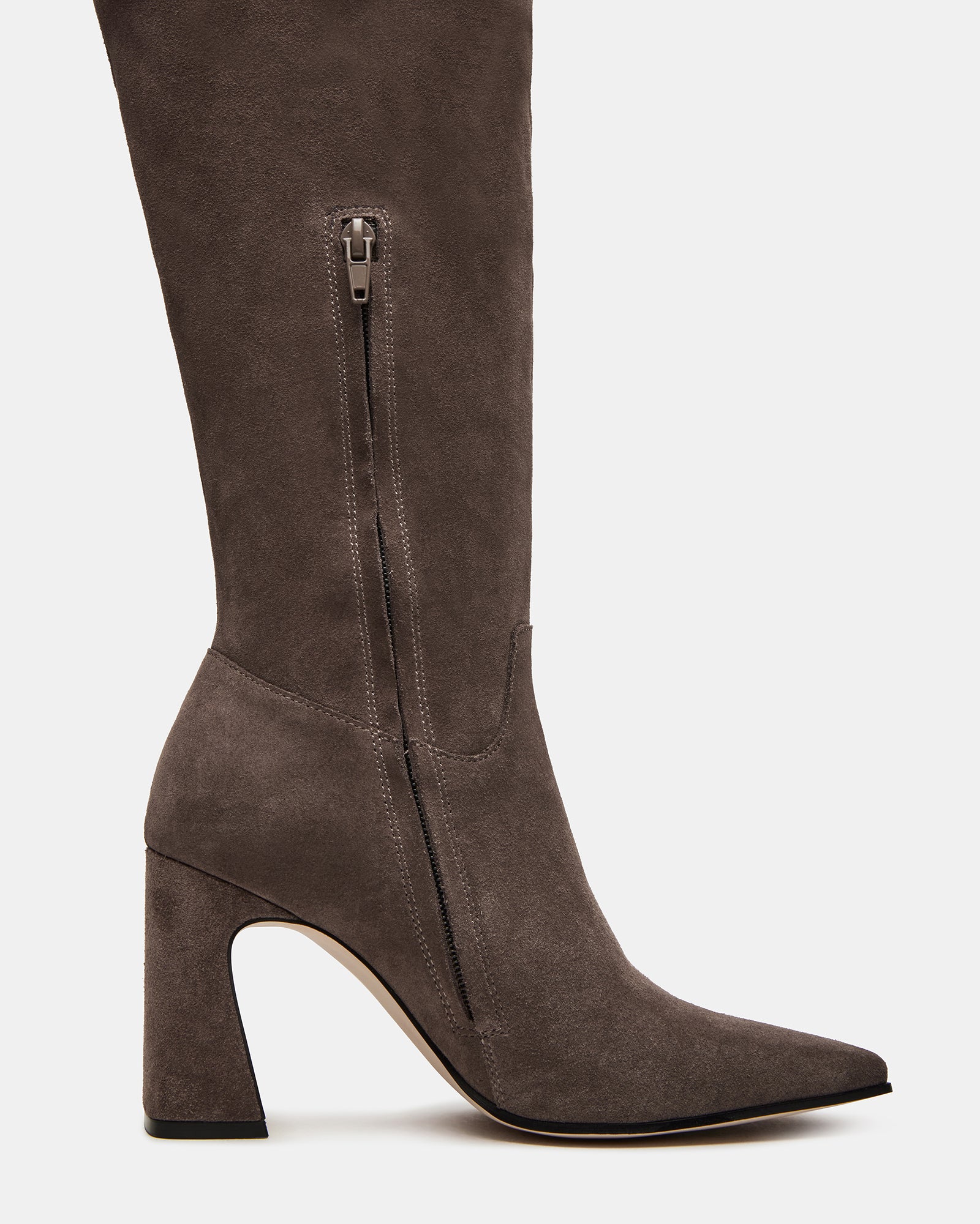 Side view of grey suede over the knee black boots styled with jeans