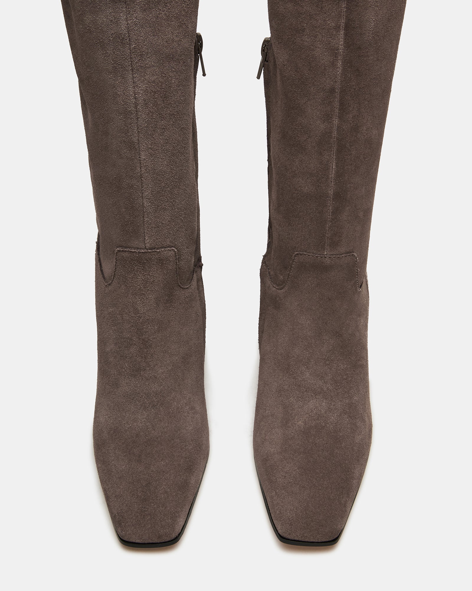 Front angle showing square toe and high heel boots on hardwood flooring
