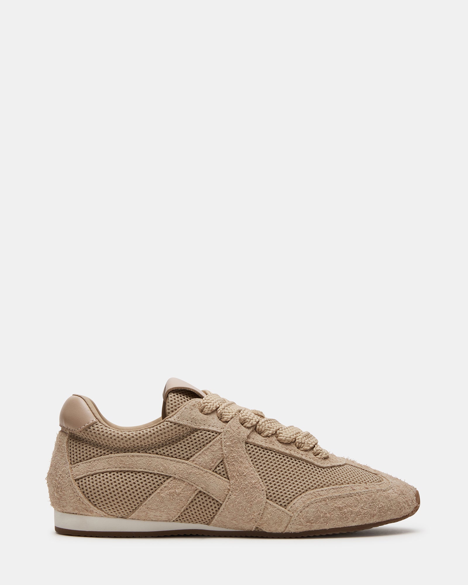 Stride Blush lace-up sneakers viewed from above on a grassy field.
