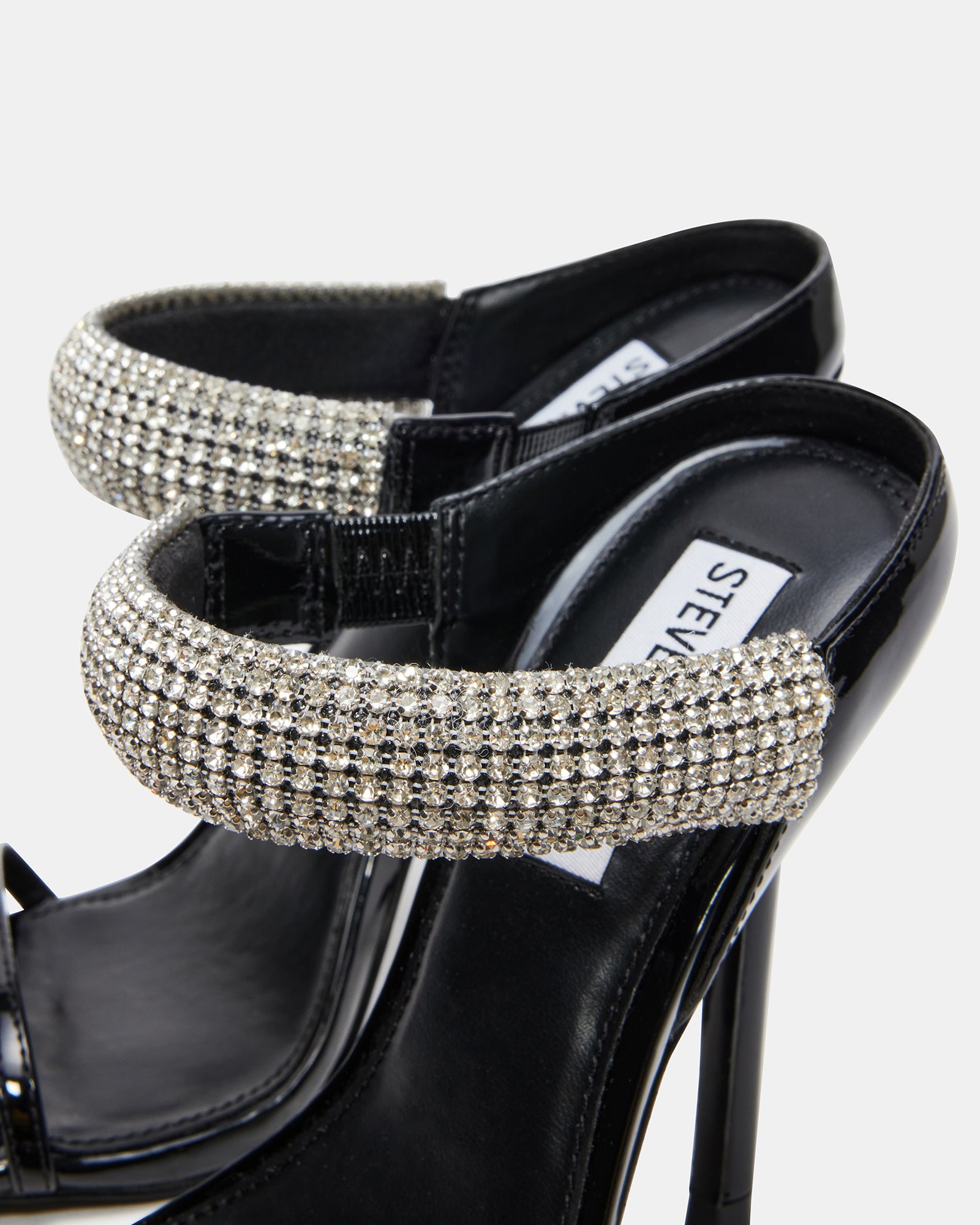 Stylish black rhinestone heels displayed from the side.