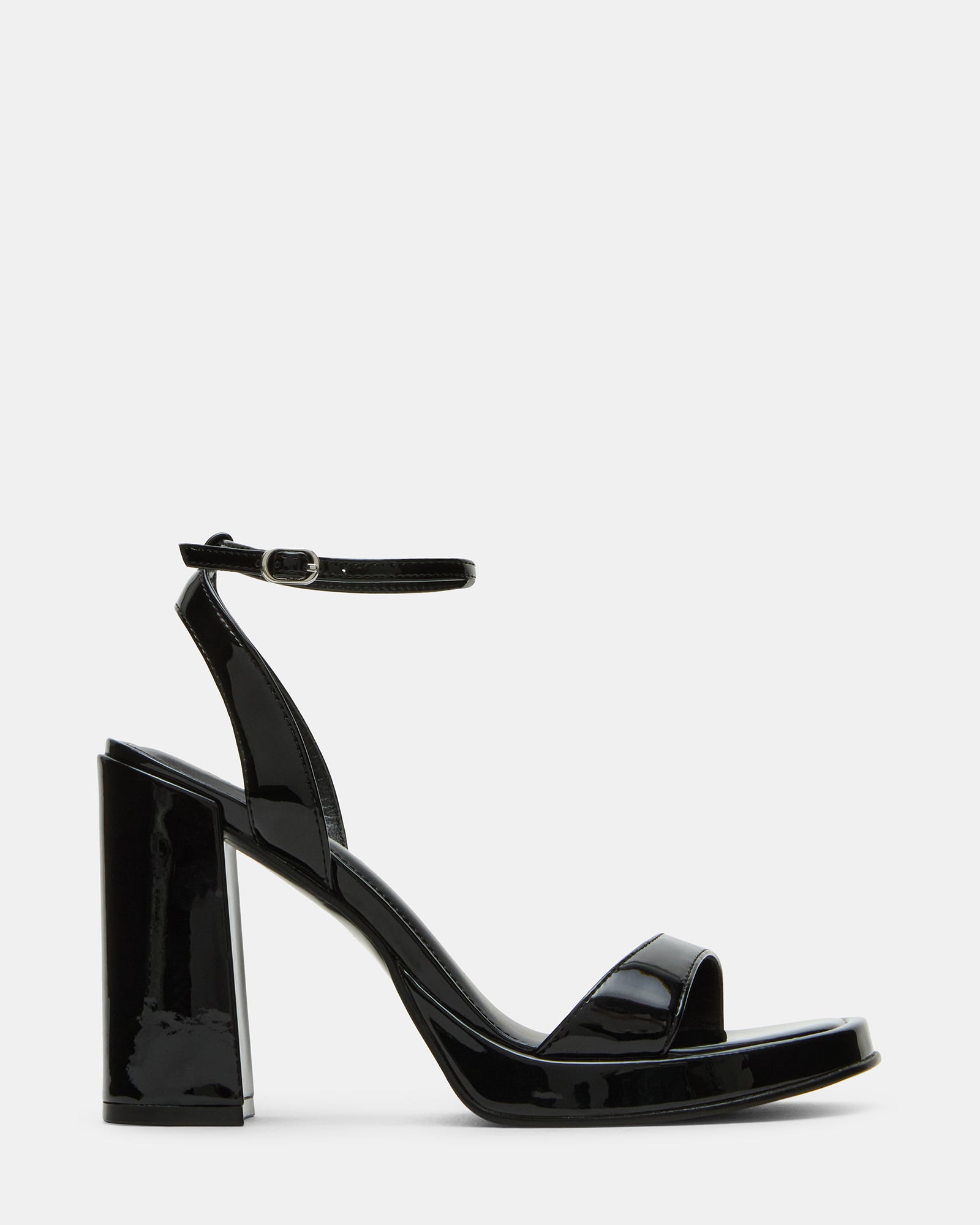 Close-up of black strappy sandals showing square toe and glossy finish