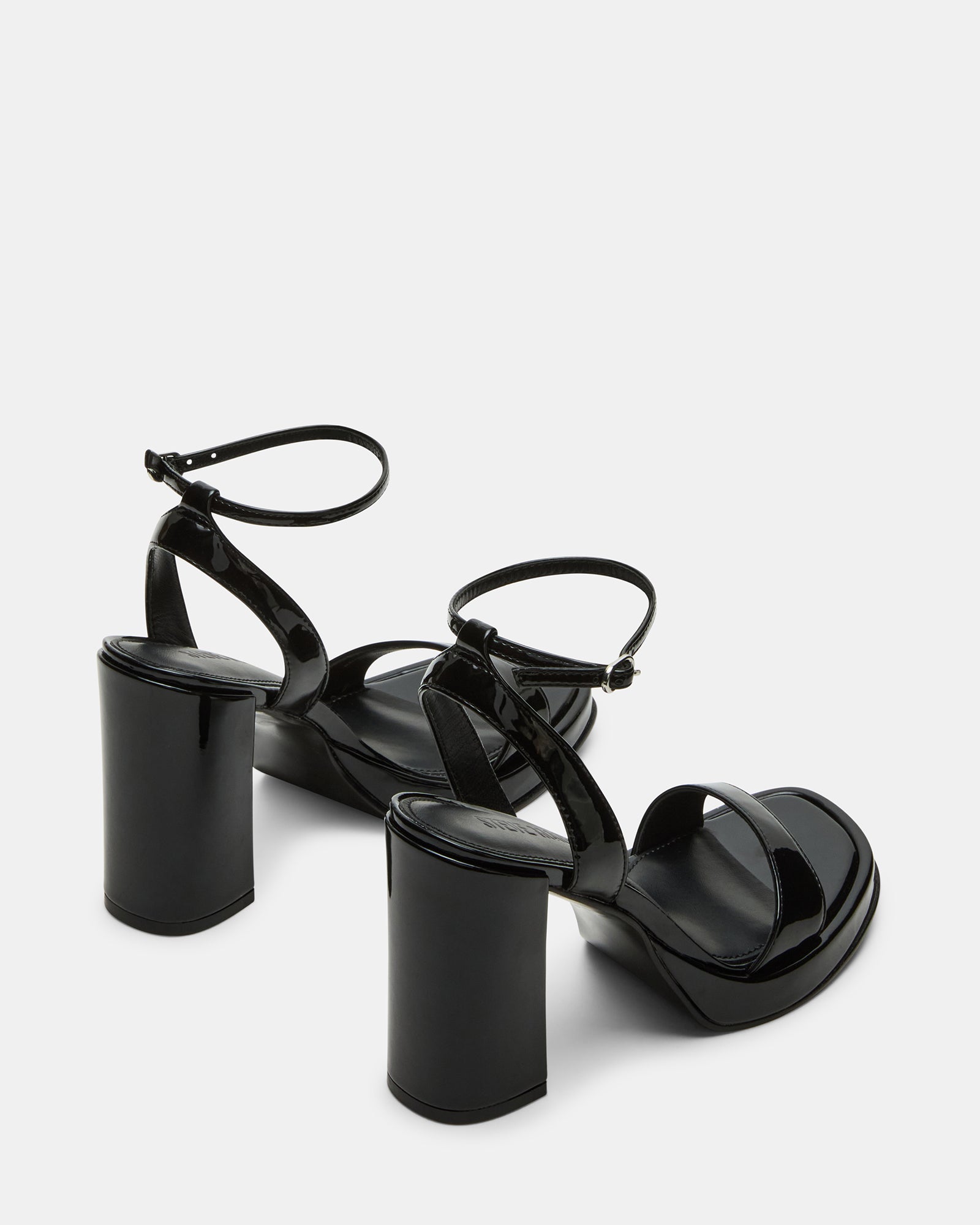 Rear angle of block heel shoes sandals styled for Chicago rooftop evening