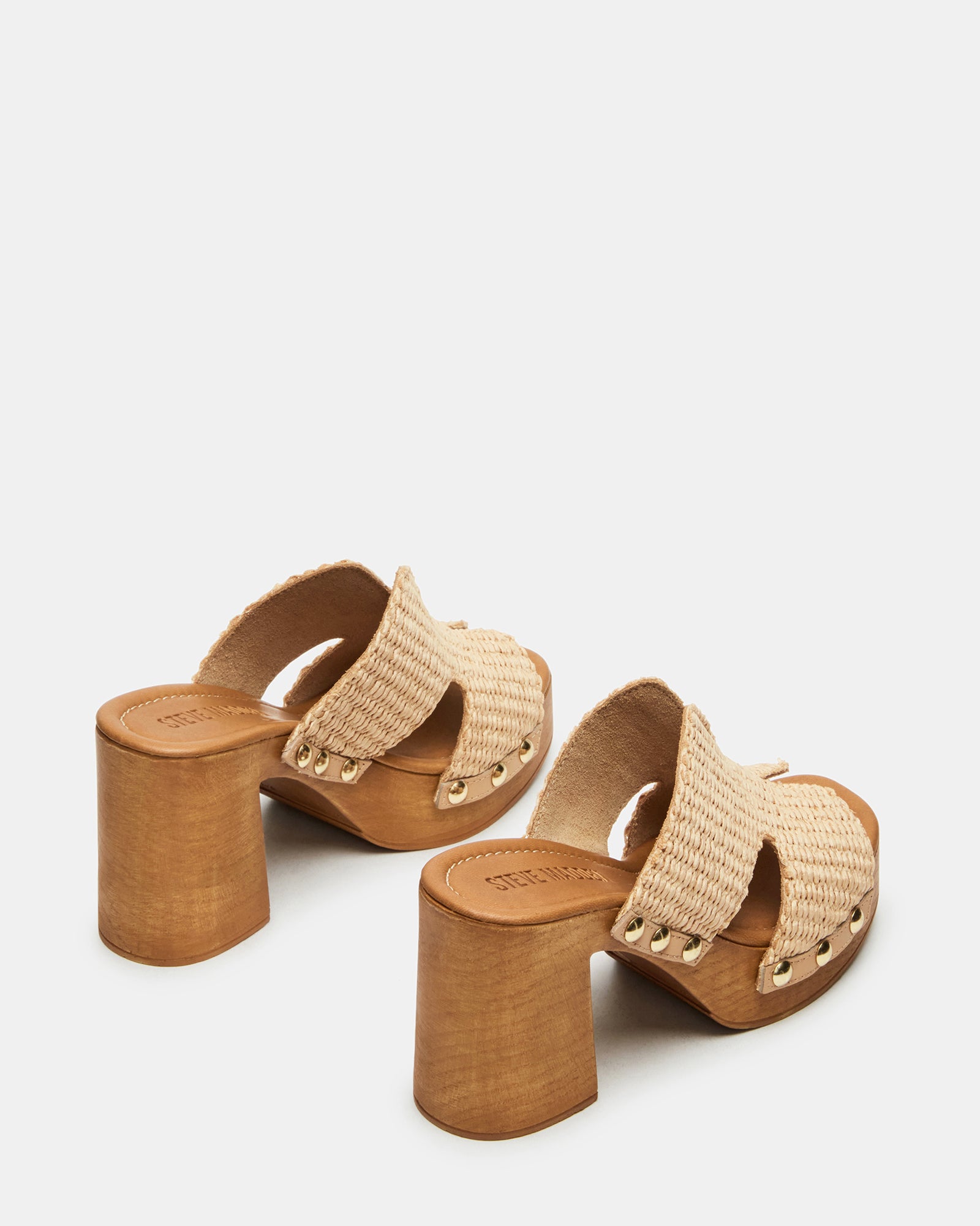 Flat lay of raffia platform sandals with natural textures and trendy design
