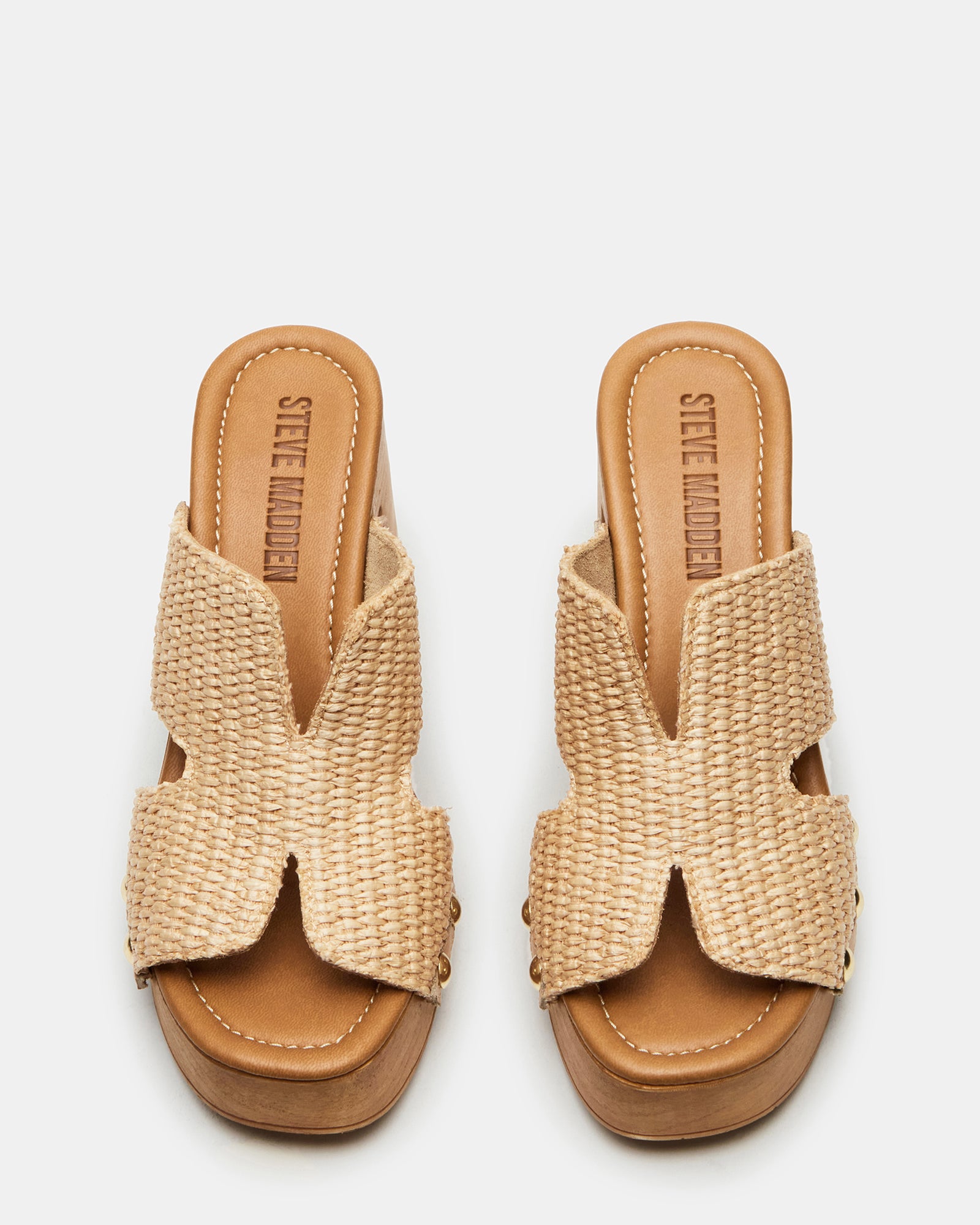 Model walking in raffia sandals with a summery dress, showcasing the sturdy wood bottom