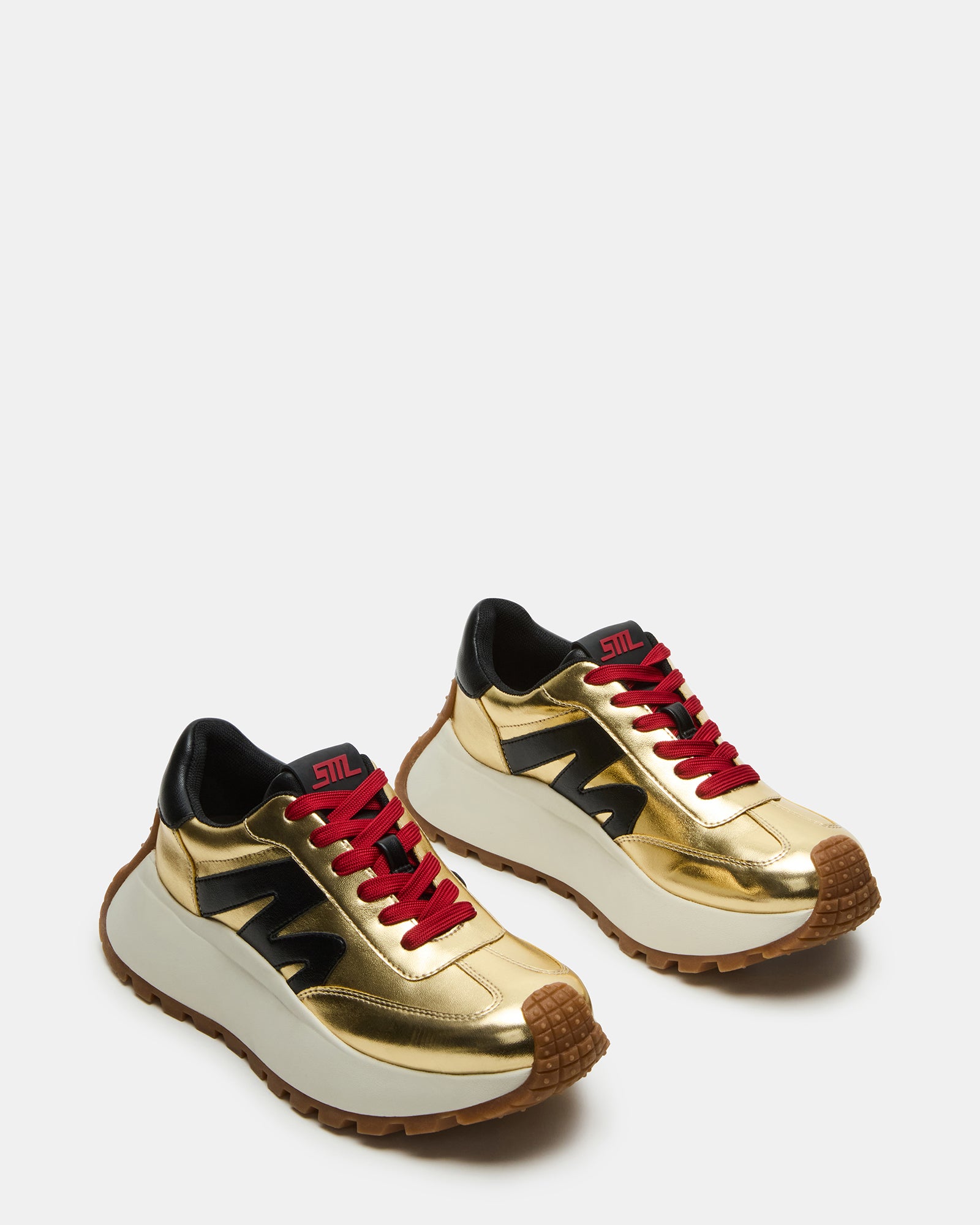Close-up of chunky sole and lace detailing on white platform sneakers