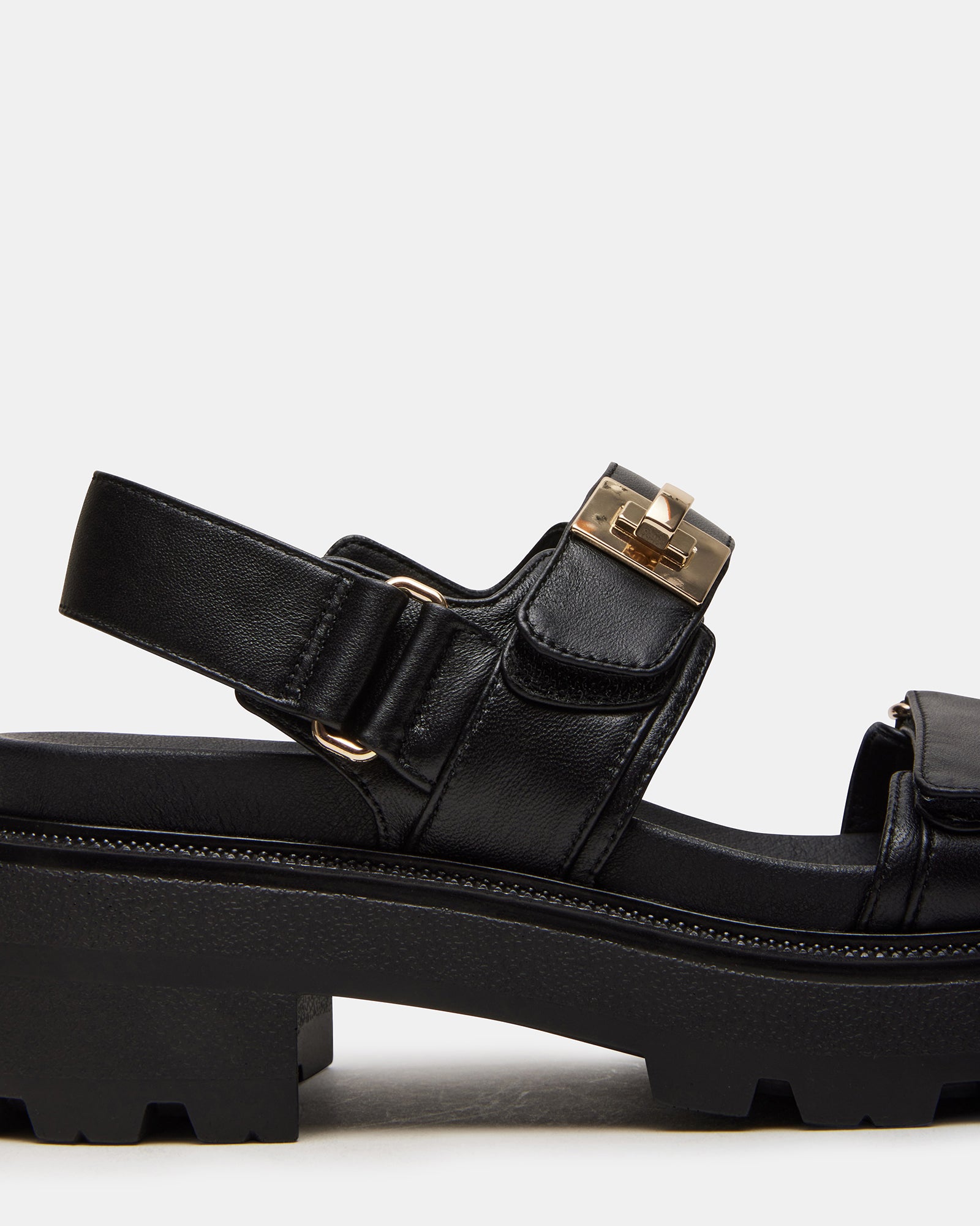 Model wearing SuperMona black leather sandals styled with casual outfit for everyday wear