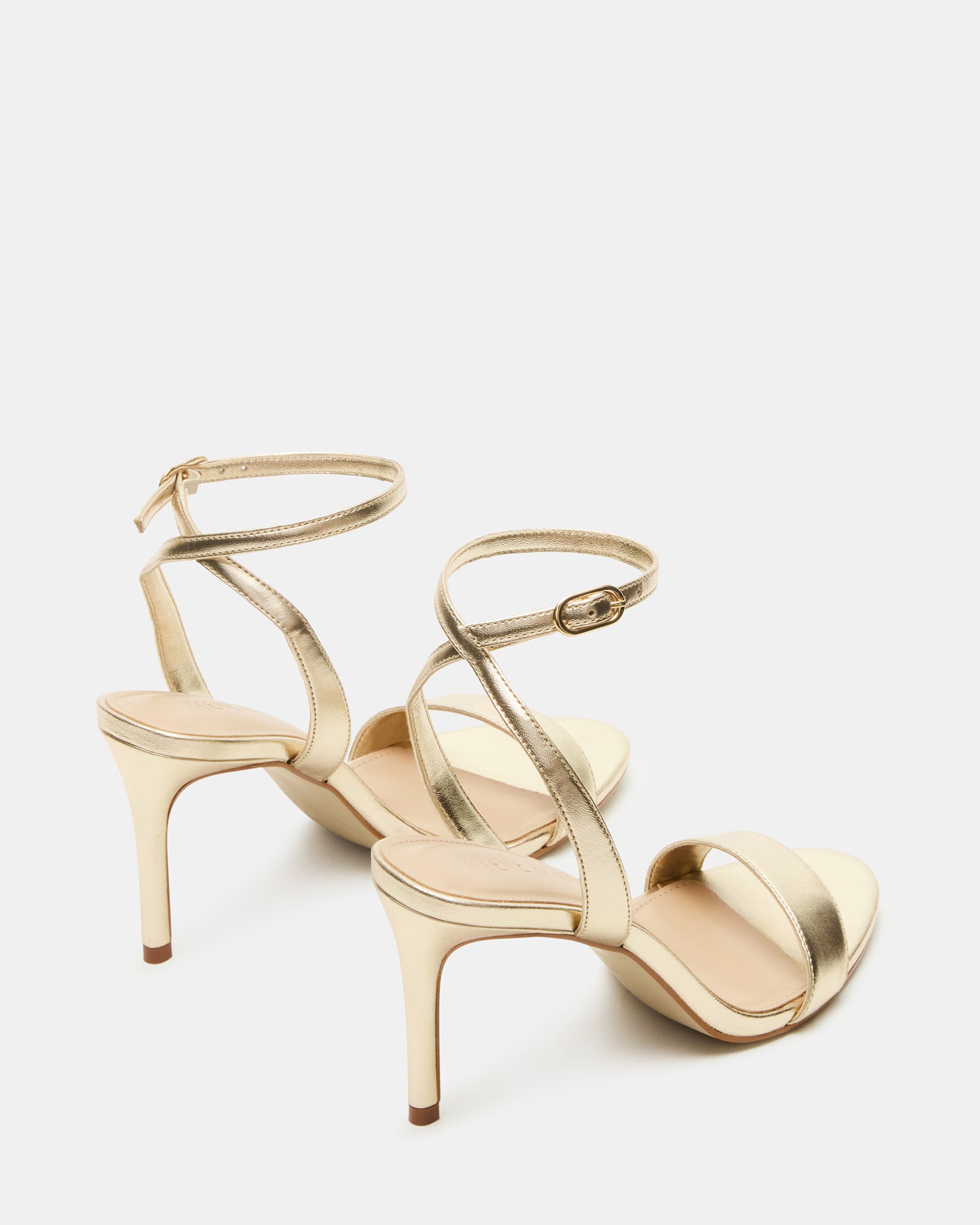Closeup of platform stiletto heels and secure ankle strap, showing textured synthetic sole