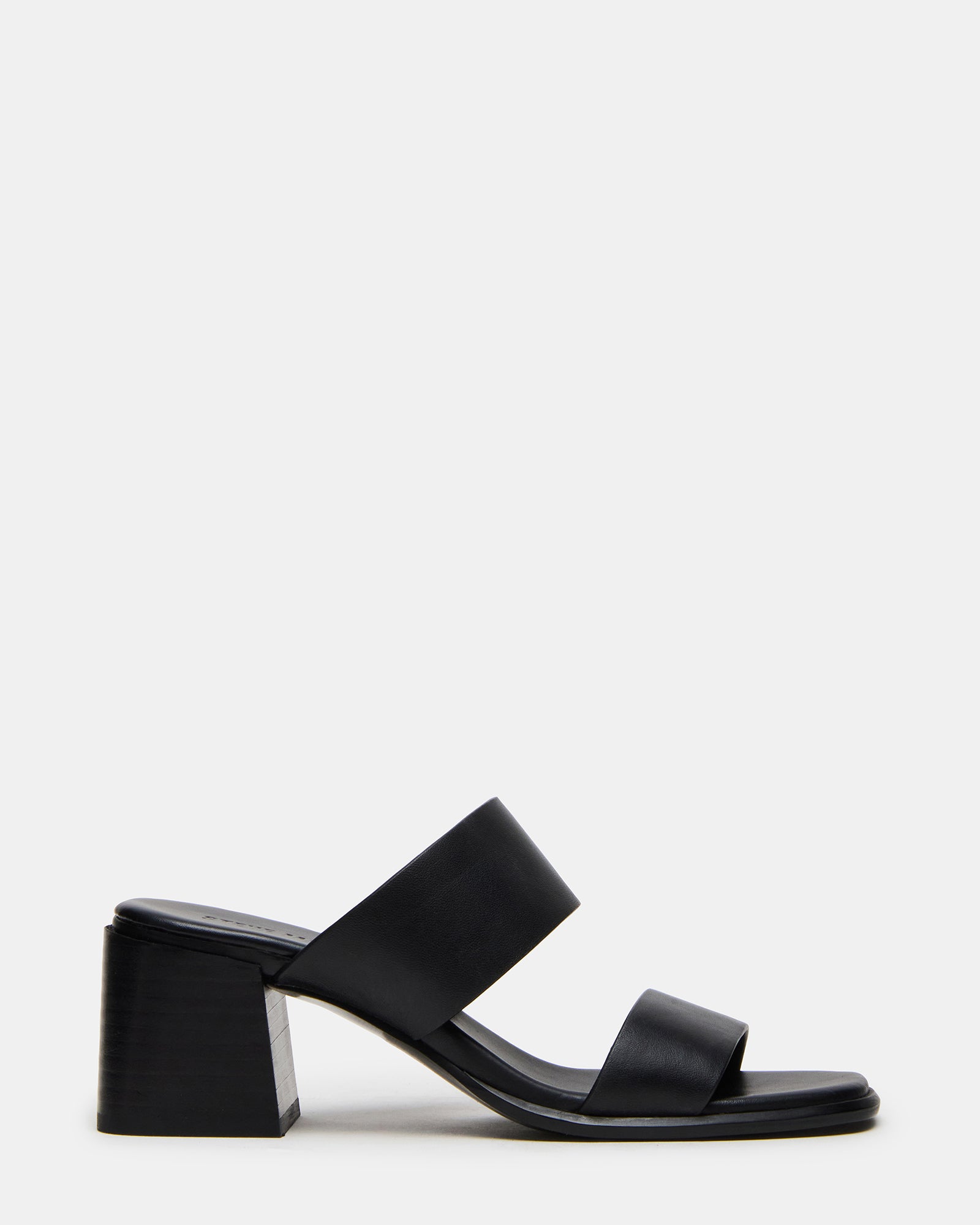 Side profile of black leather mule heels showing the square toe detail