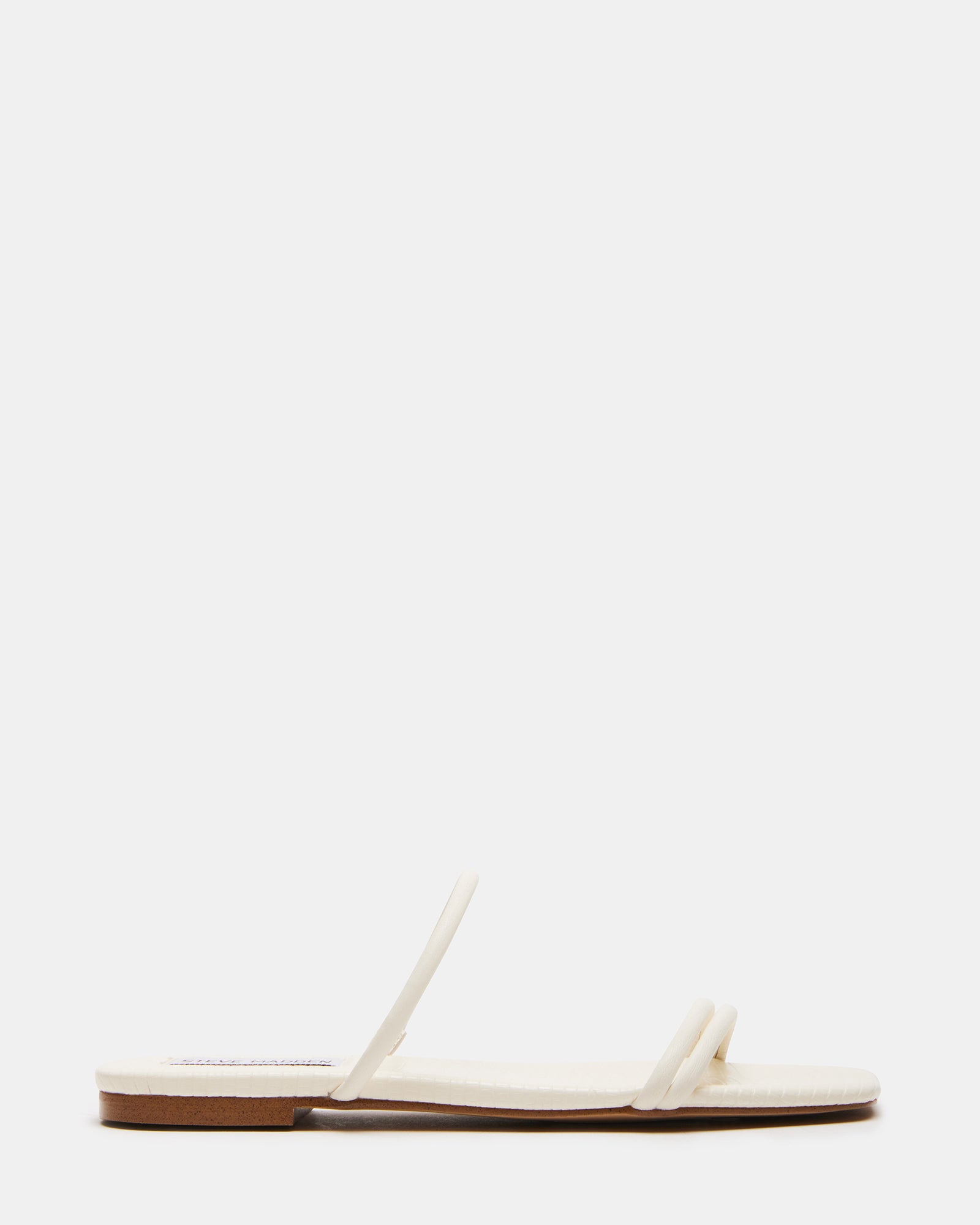 TAHITI BONE black flat slide sandals from a side angle, showcasing the square toe design.