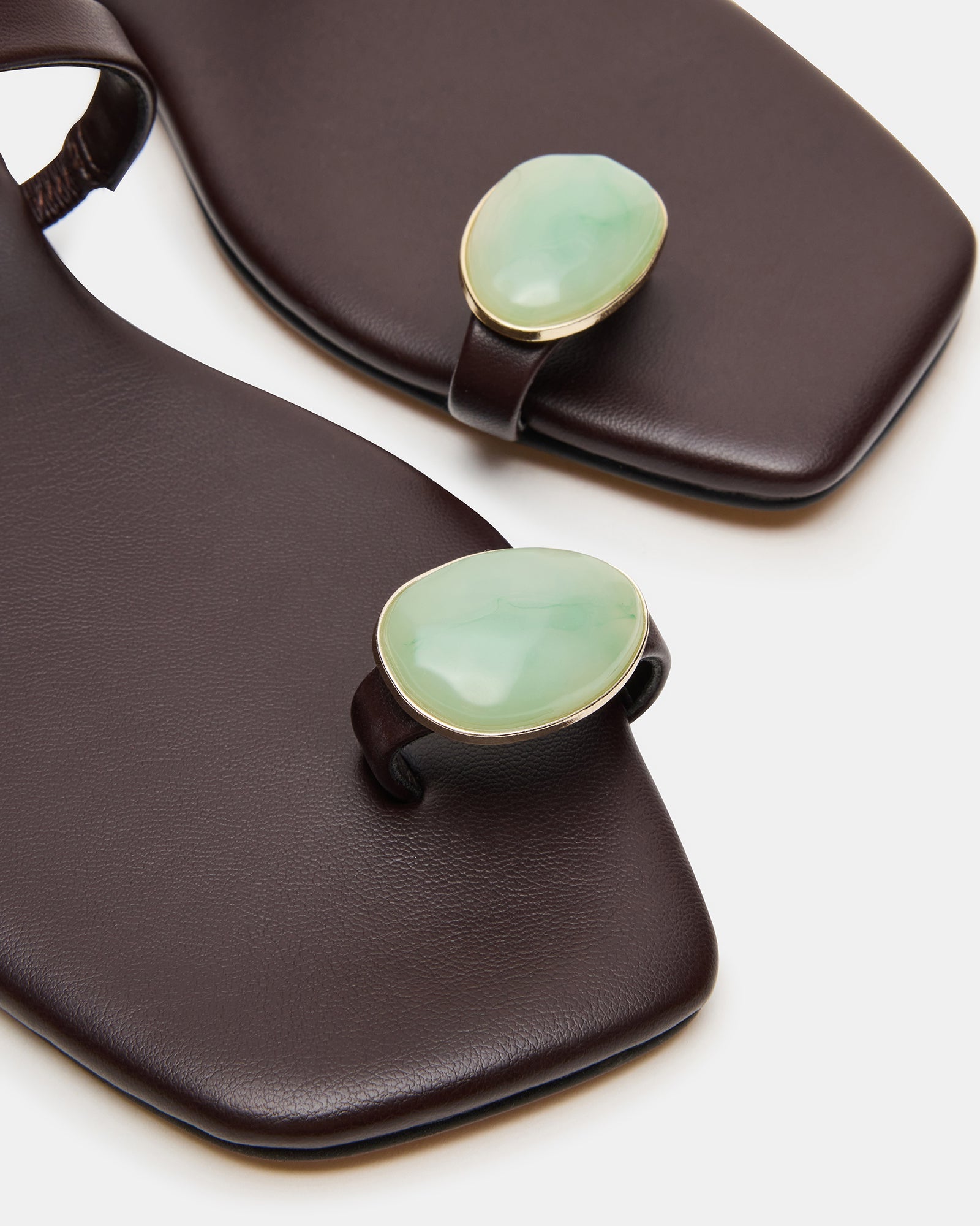 Brown leather sandals paired with a handbag and sunglasses for styling inspiration