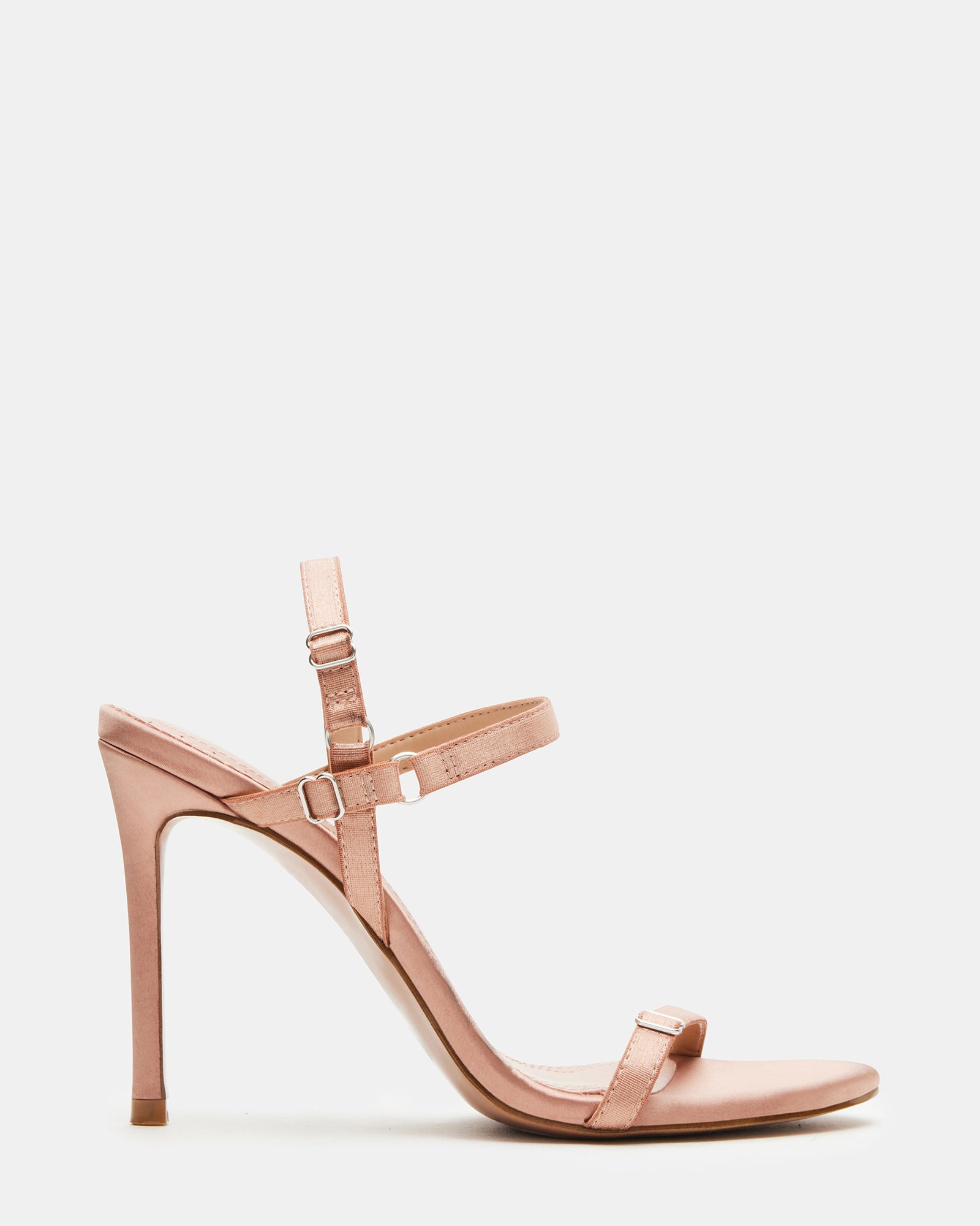 Side view of TANA blush satin open toe heels with straps on a model