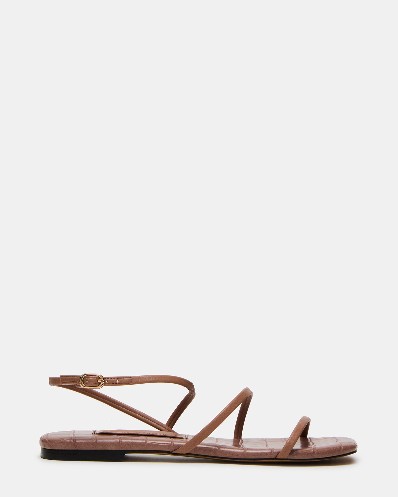 Black strappy sandals styled with linen pants for a summer look