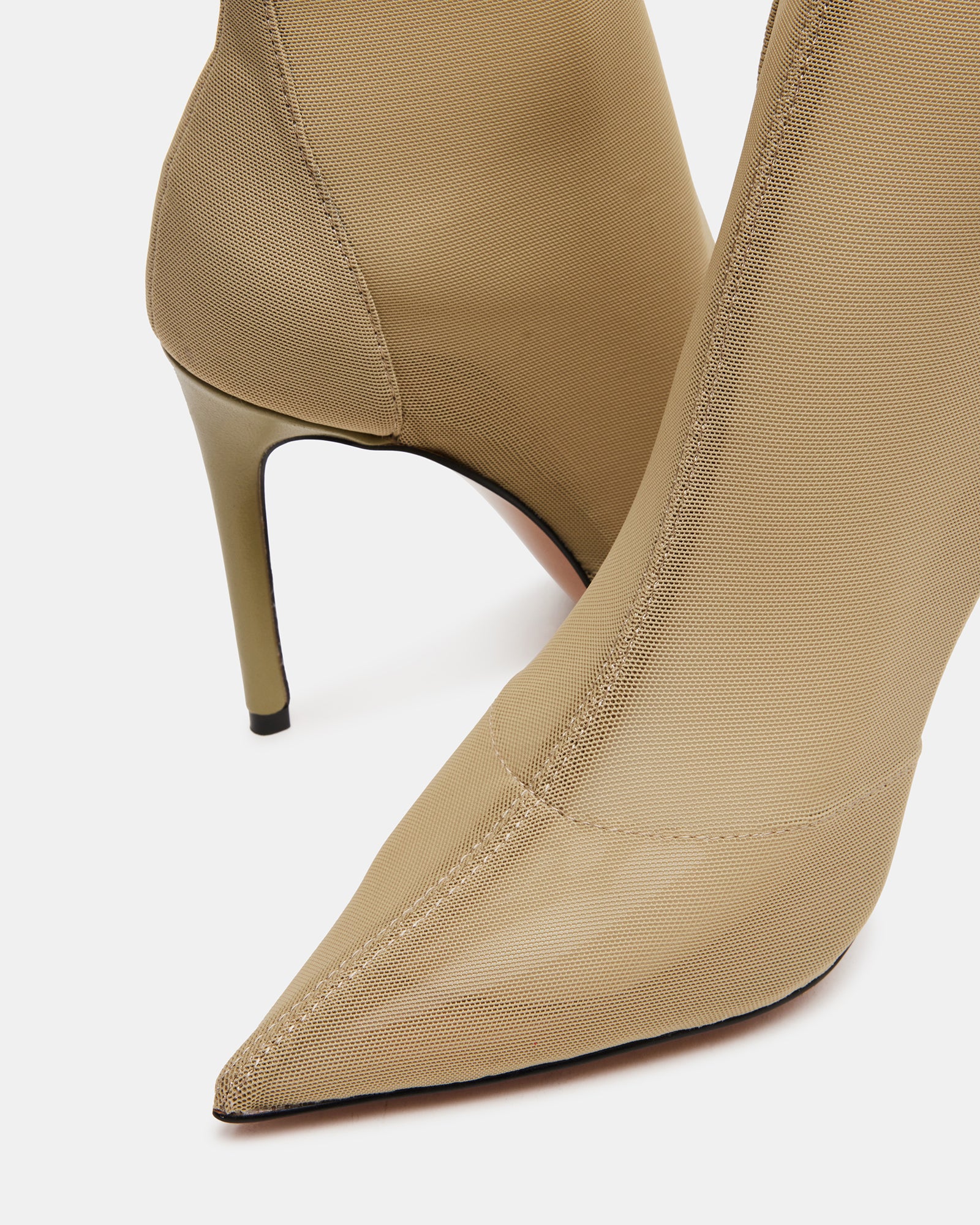 TATE Olive stiletto boots styled with a fashionable outfit.