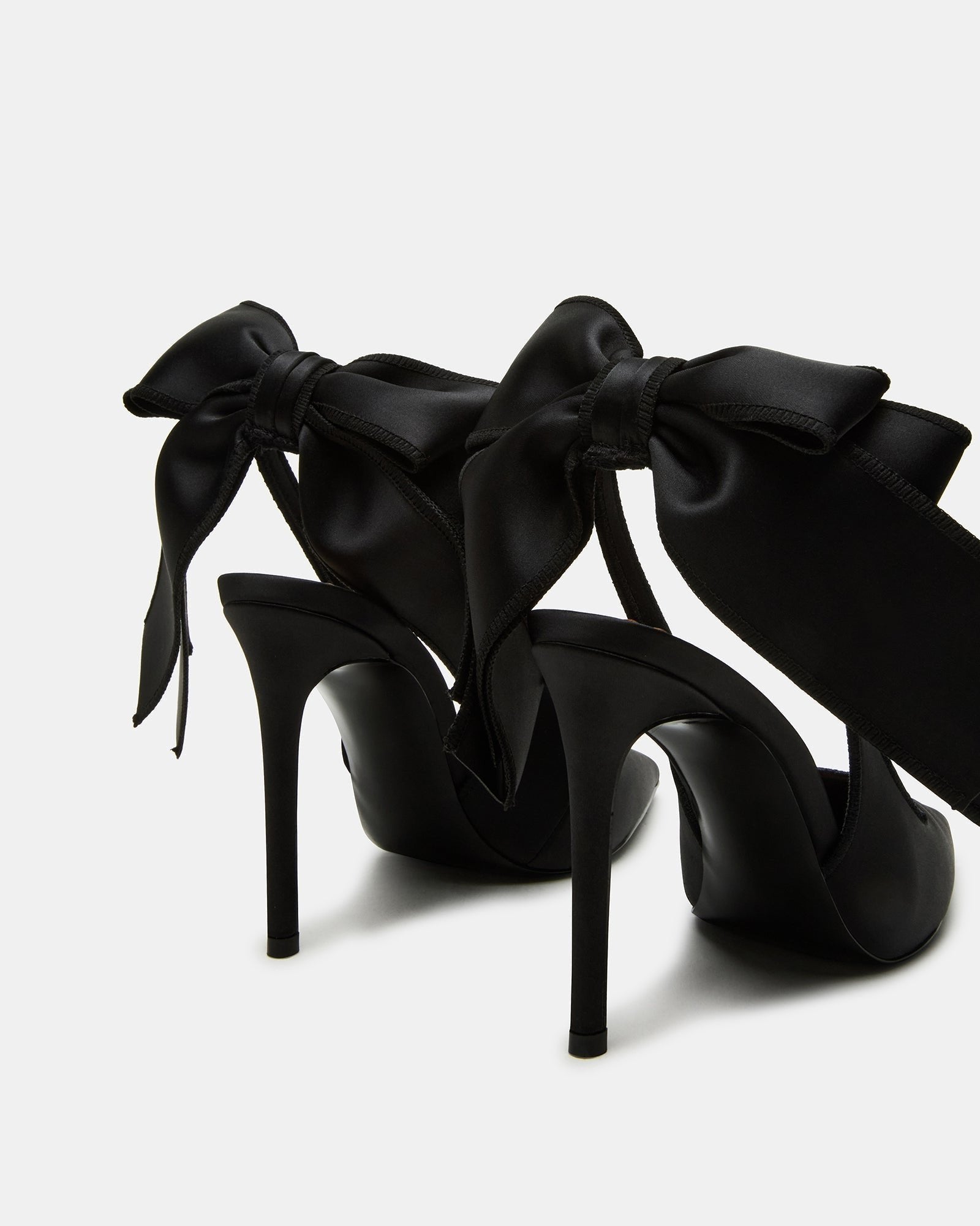 Black satin slingback heels from a side angle, showcasing the stiletto heel.