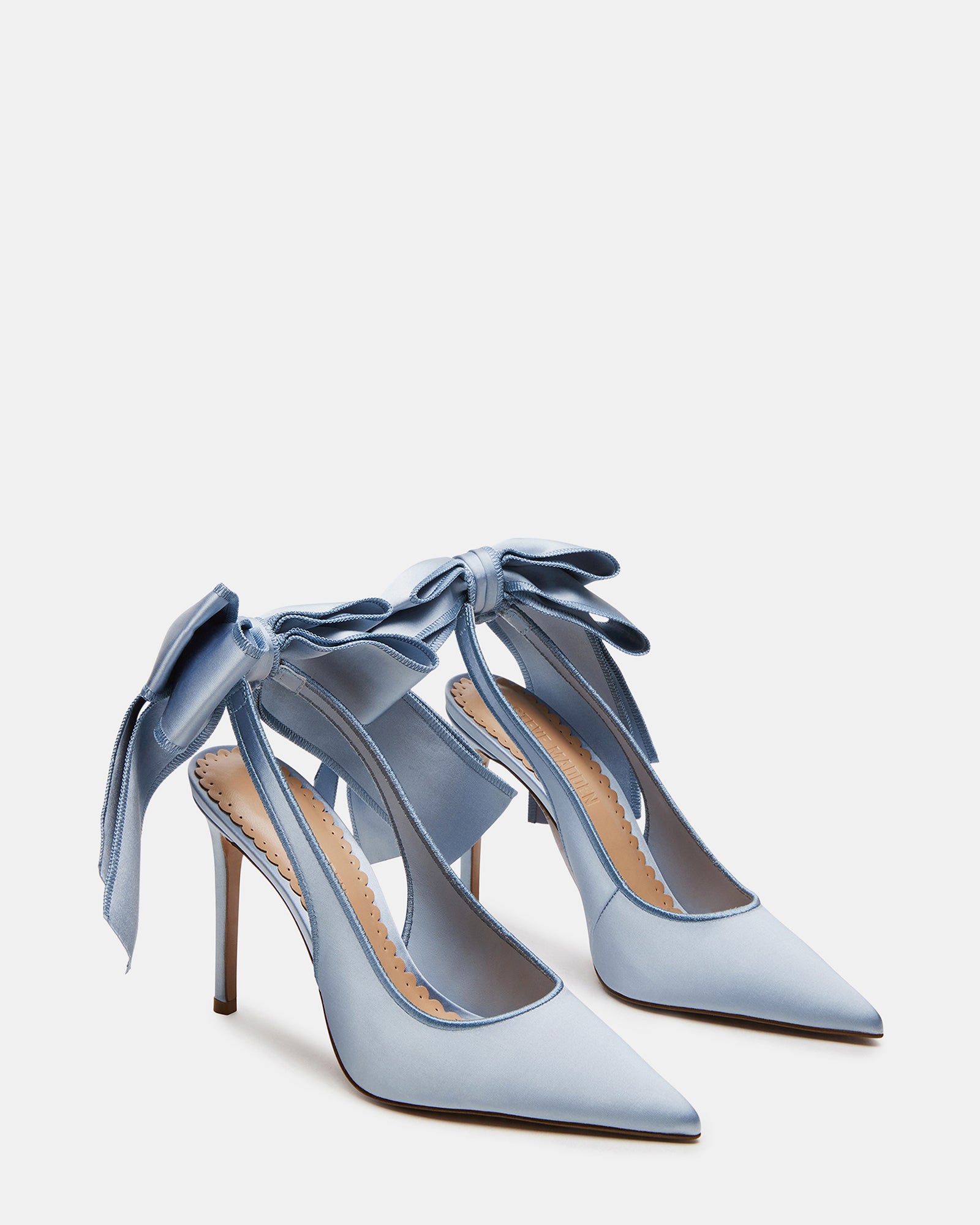 Close-up of the heel and pointed toe design on blue satin slingbacks