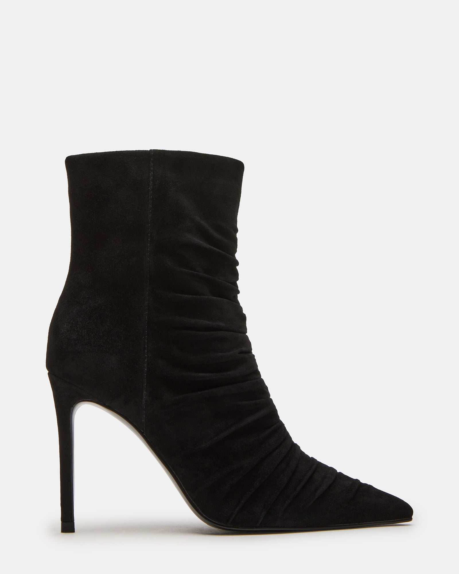 Black suede pointed toe ankle booties with stiletto heel on a stylish model