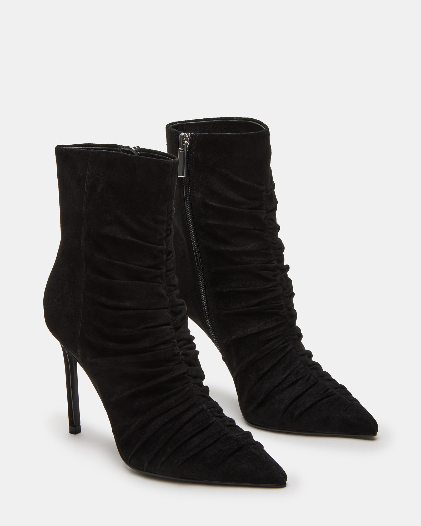 Side view of black suede ankle boots showcasing the pointed toe and sleek heel