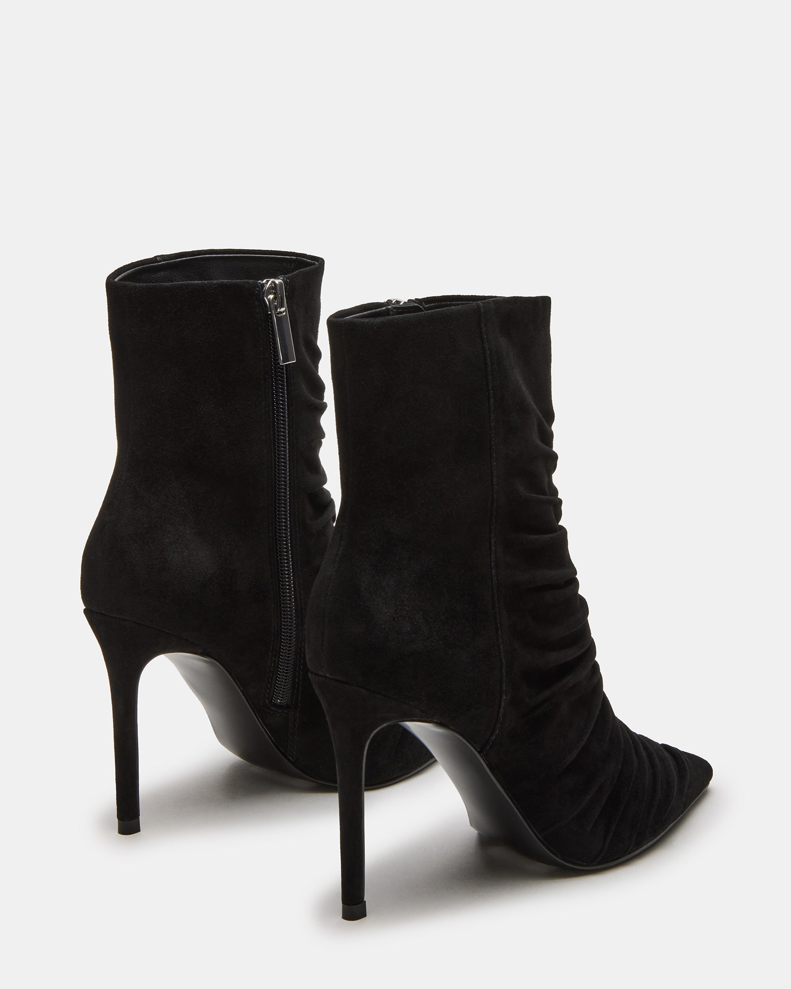 Side view of black suede ankle boots showcasing the pointed toe and sleek heel