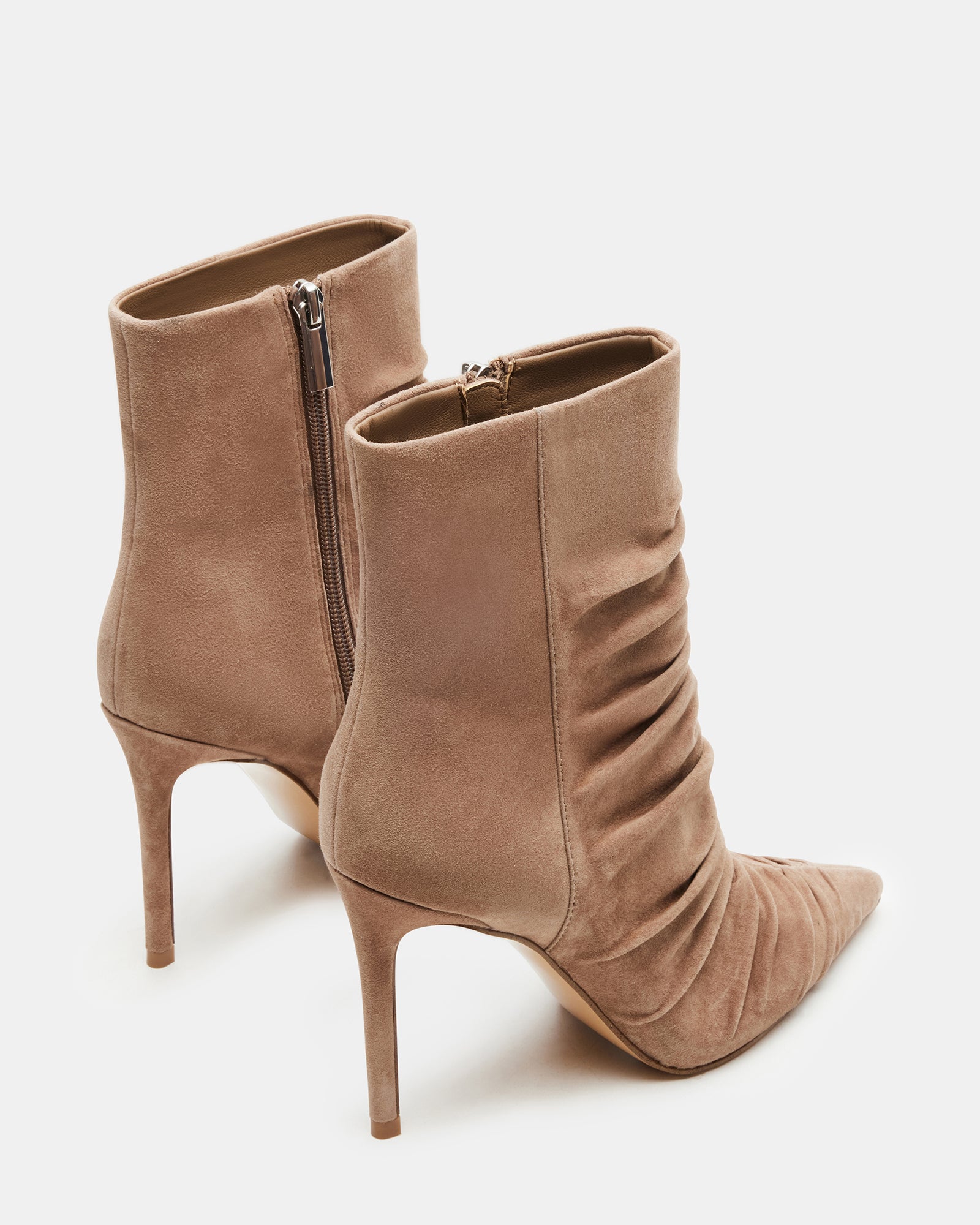 Back view showing heel height and sleek suede finish of the taupe bootie