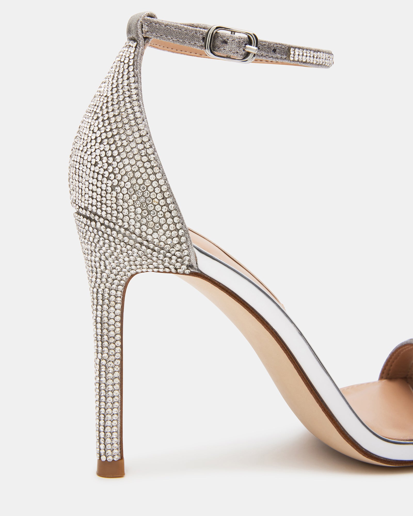 Close-up of the rhinestone straps and buckle closure on black high heel sandals.