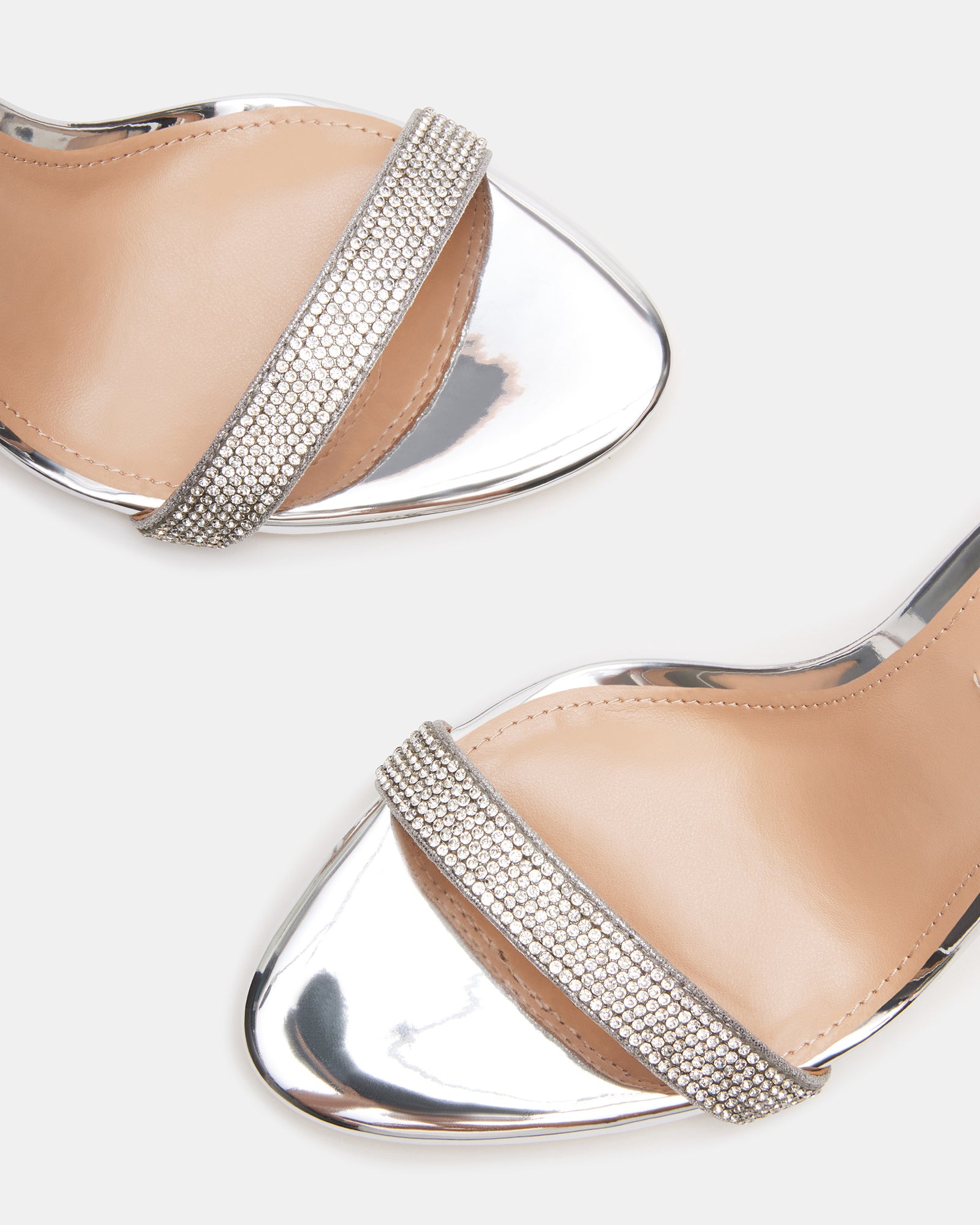 Tecy rhinestone sandals worn with a cocktail dress, showcasing the stiletto heel and sparkle.