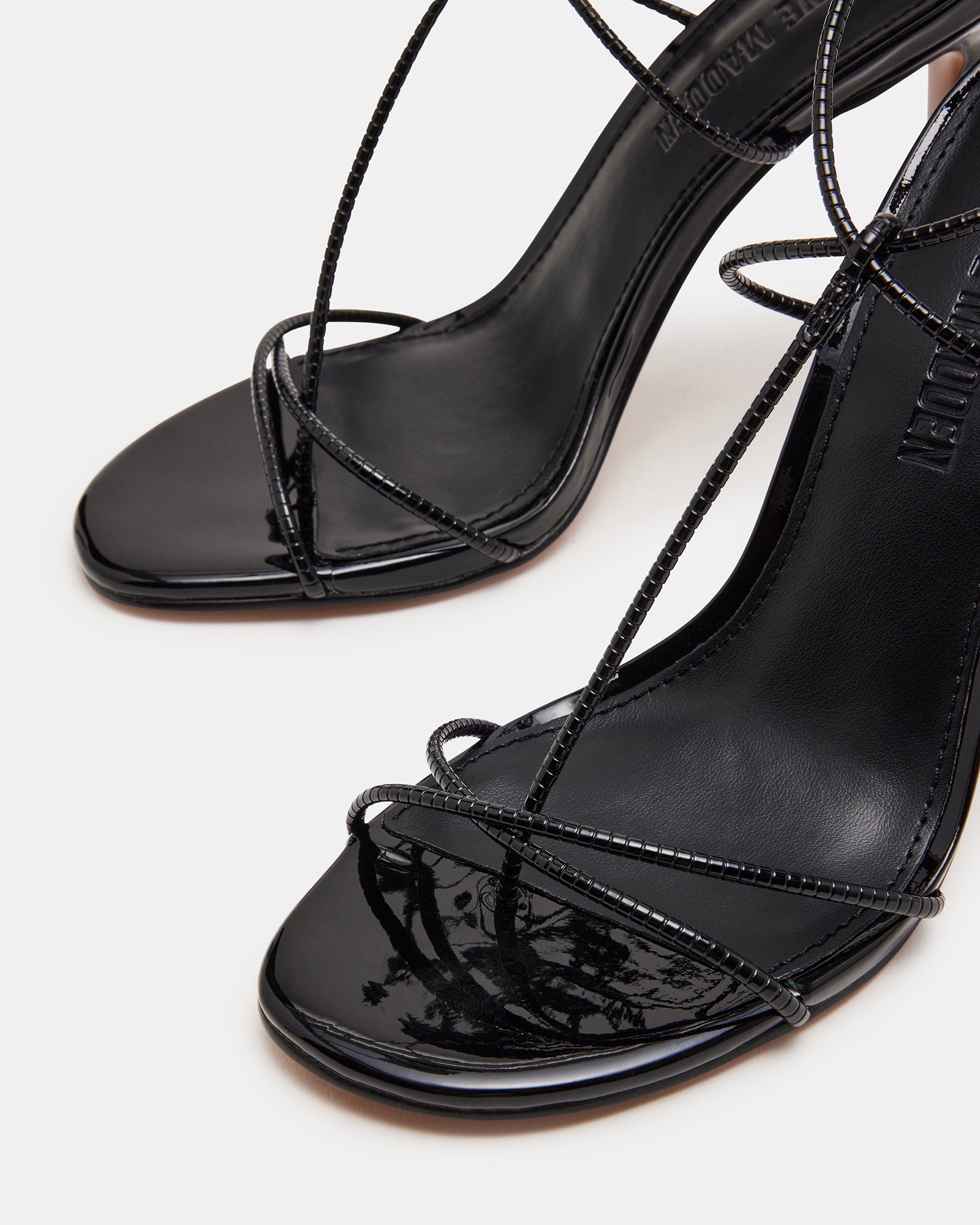 Temptation Noir black stiletto heels styled with a fashionable outfit for a night out.