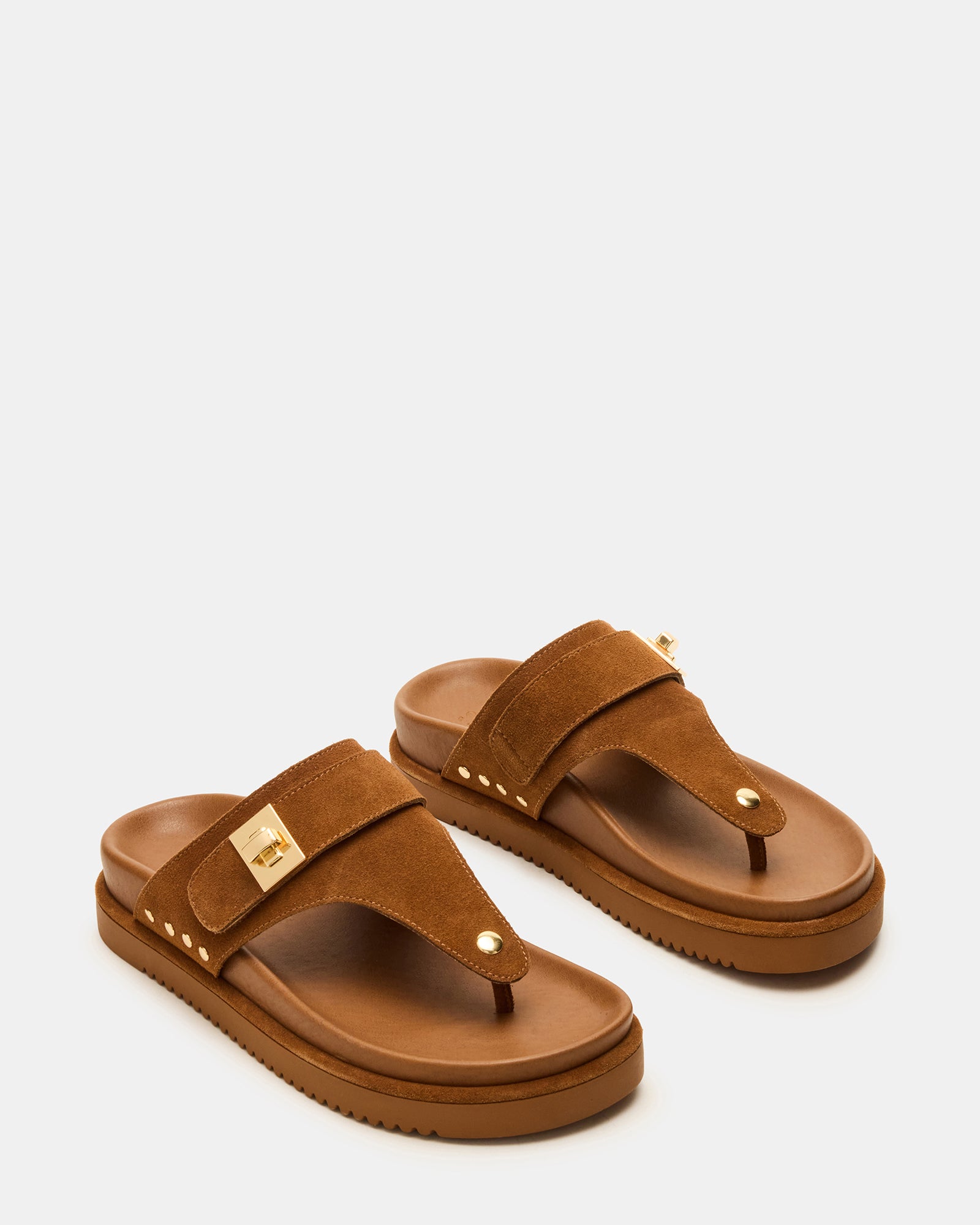 Model wearing Thona chestnut suede sandals at a summer event