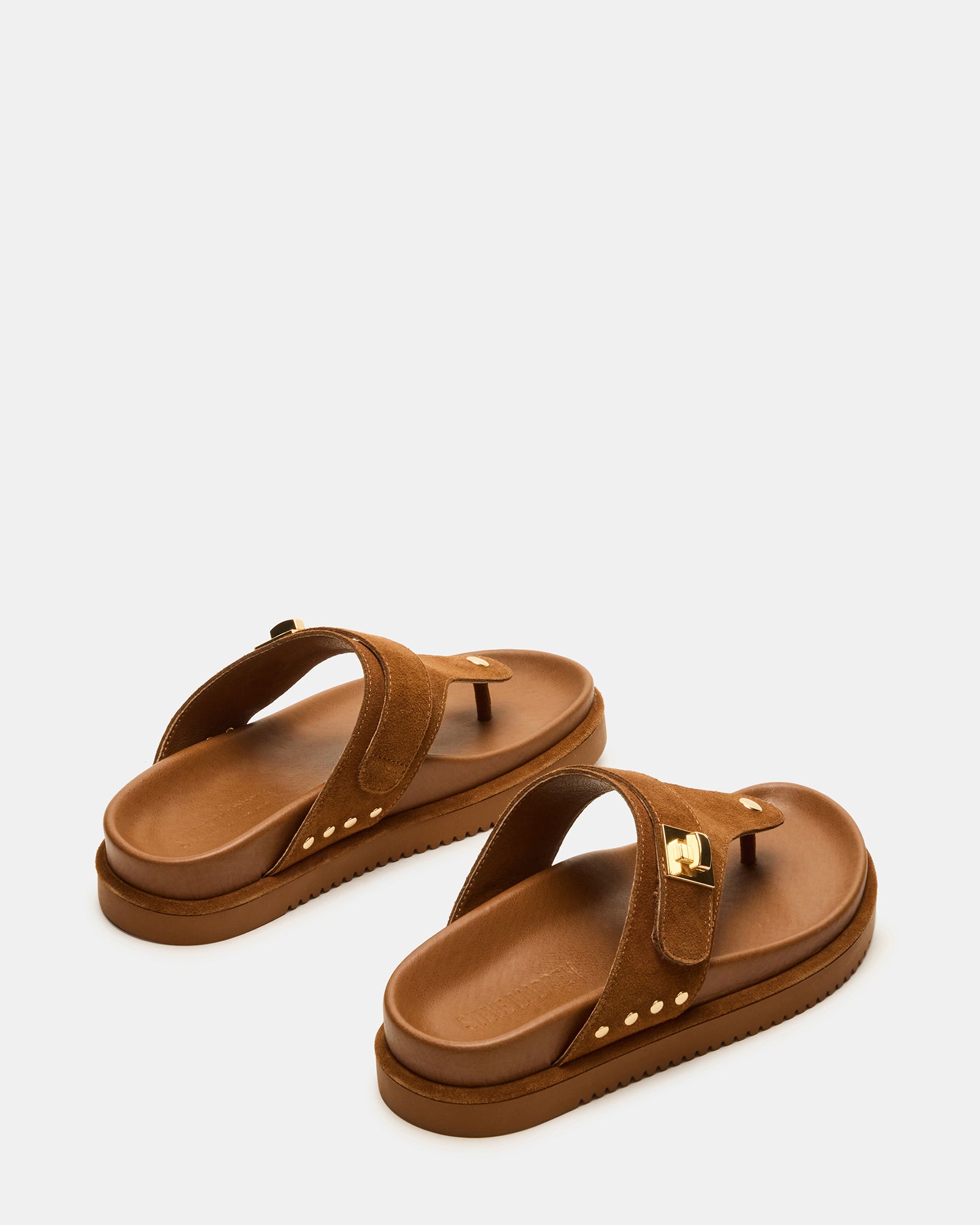 Model wearing Thona chestnut suede sandals at a summer event