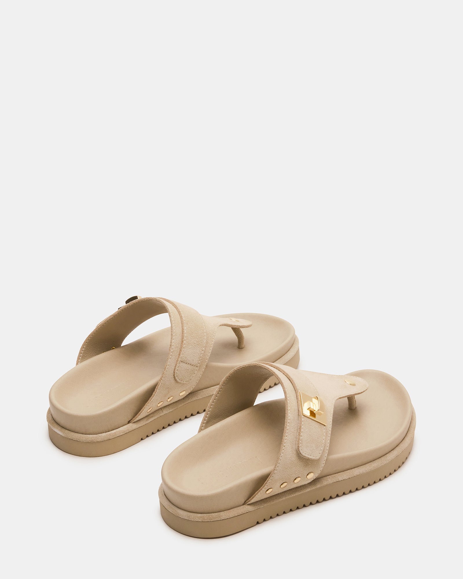 Close-up of black platform sandals showing synthetic sole and suede upper