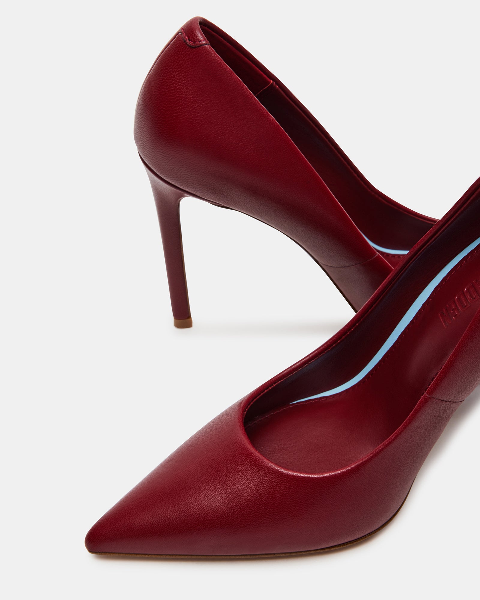 Elegant black patent leather pumps showcasing a pointed toe and stiletto heel.